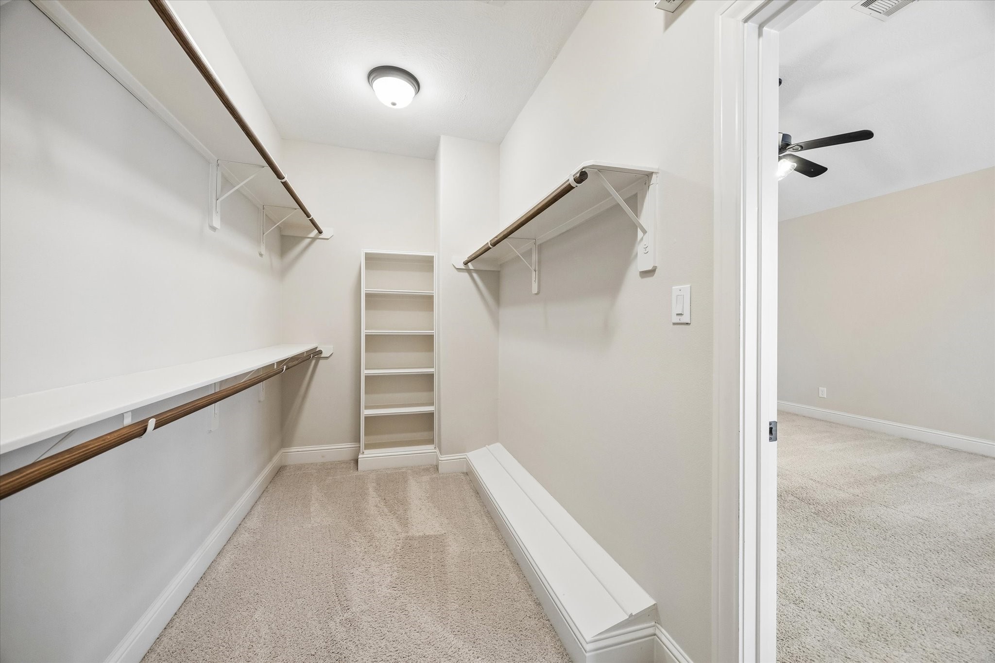 Oversized walk-in closet with built-in shelving and abundant storage space.