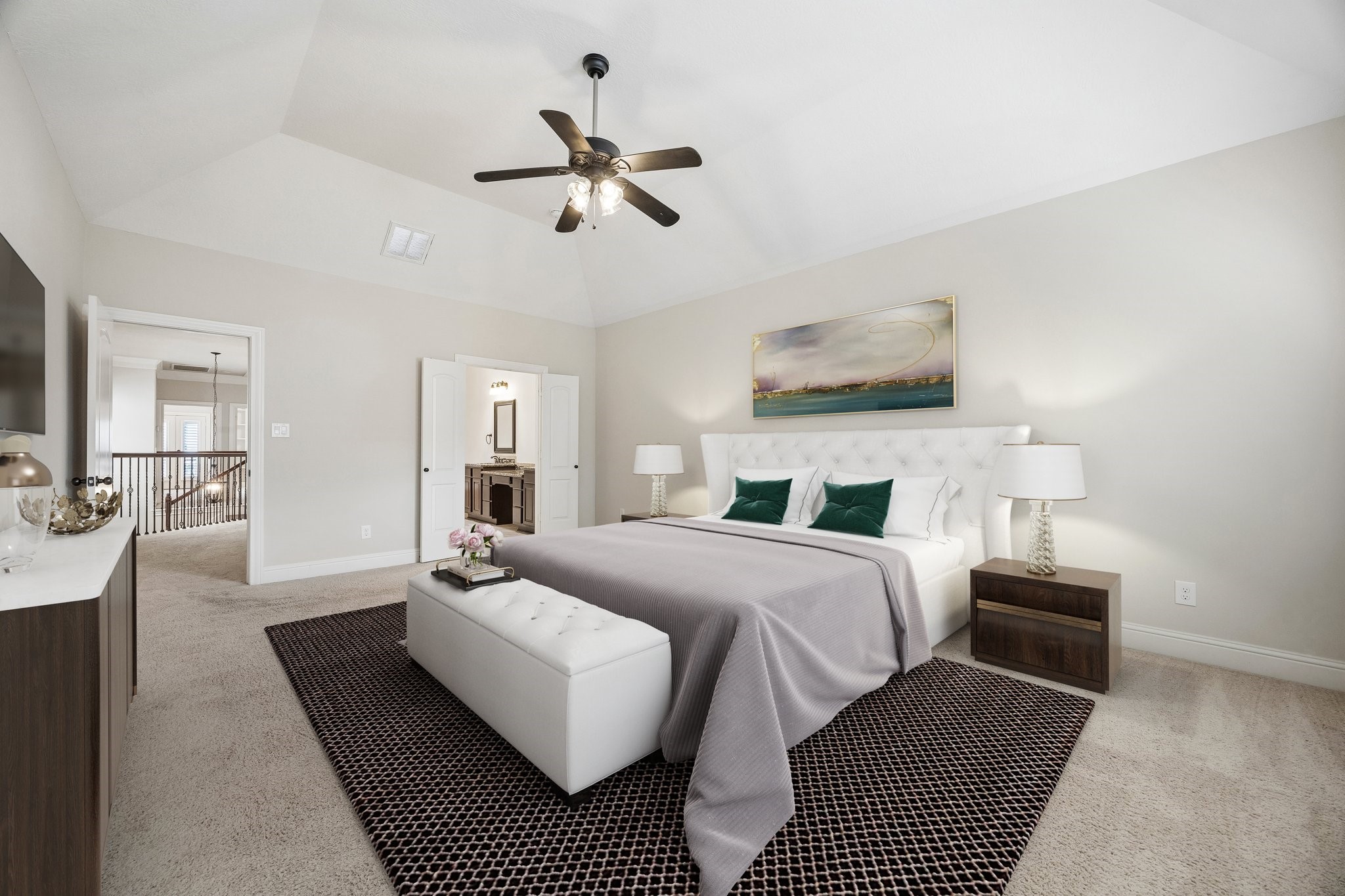Spacious primary bedroom with vaulted ceiling and room for a sitting area.