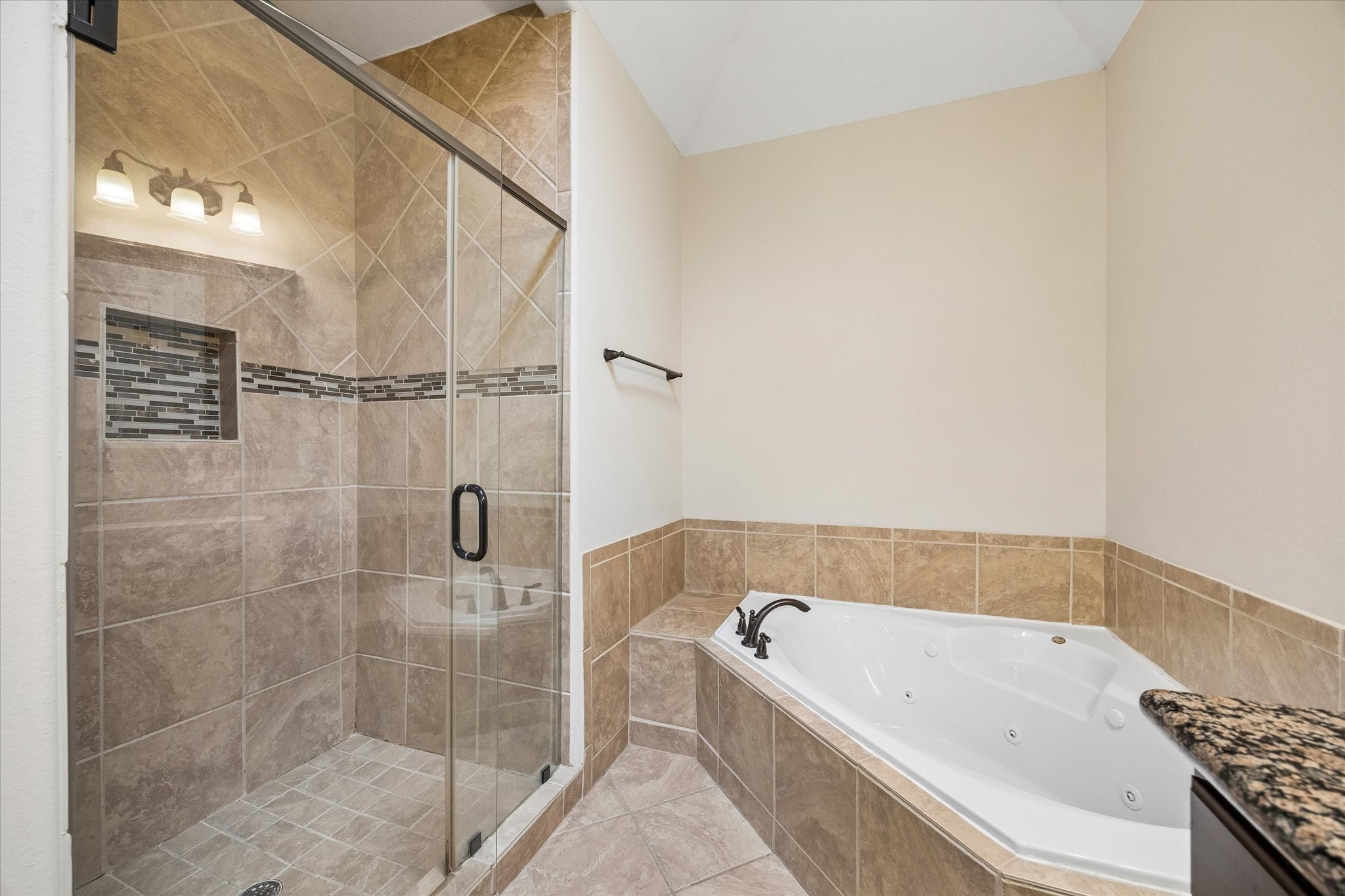 Spa-like bathroom retreat with relaxing tub and glass-enclosed shower.