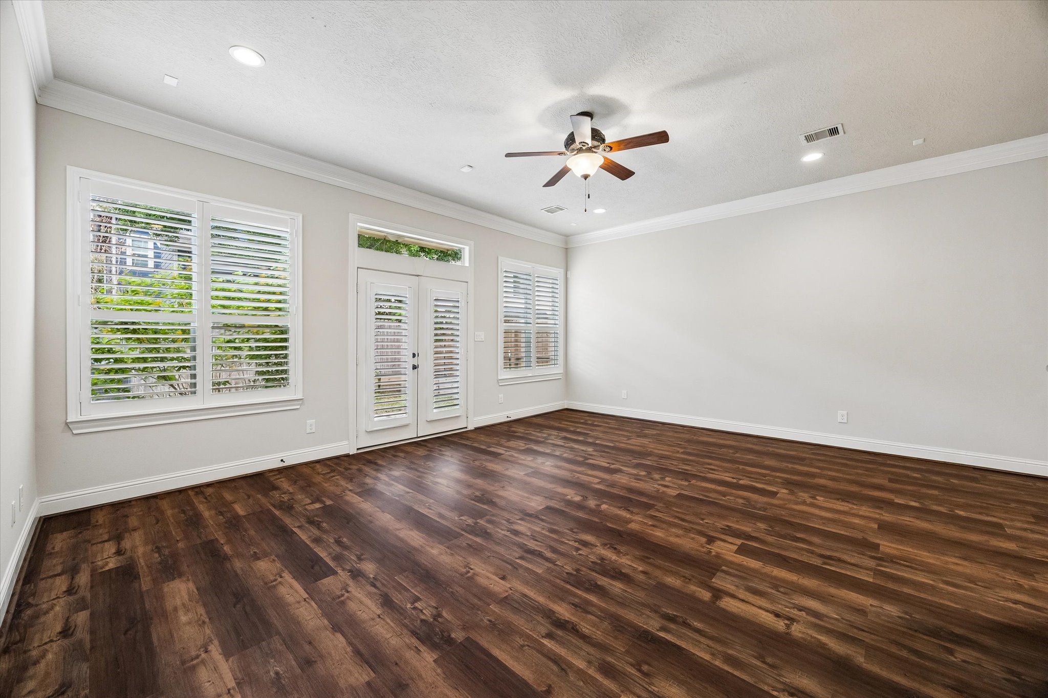 Expansive living room with abundant natural light and access to outdoor space.