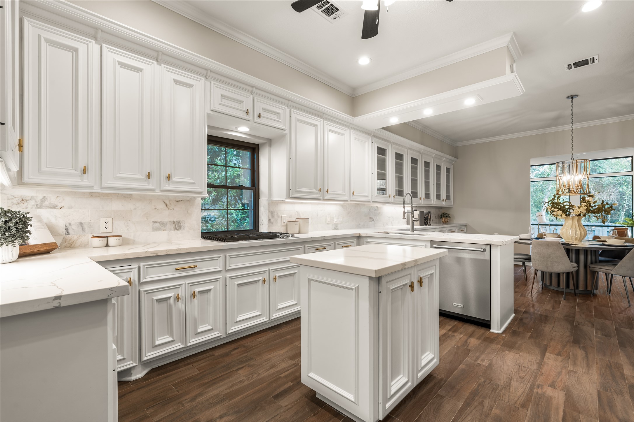 The kitchen flows seamlessly into the breakfast area, combining elegant finishes with an open layout ideal for gathering.