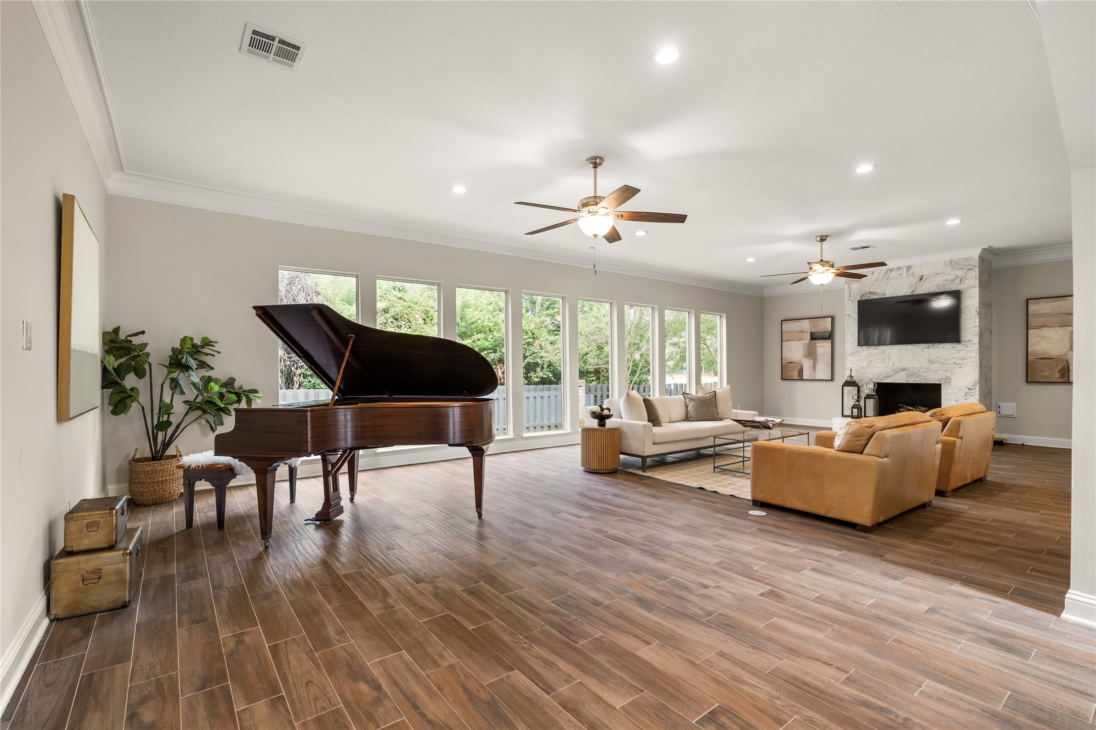 Anchored by a distinguished 1914 Chickering & Sons quarter grand piano, this expansive living space offers an elegant setting for entertaining, intimate gatherings, and memorable evenings at home.