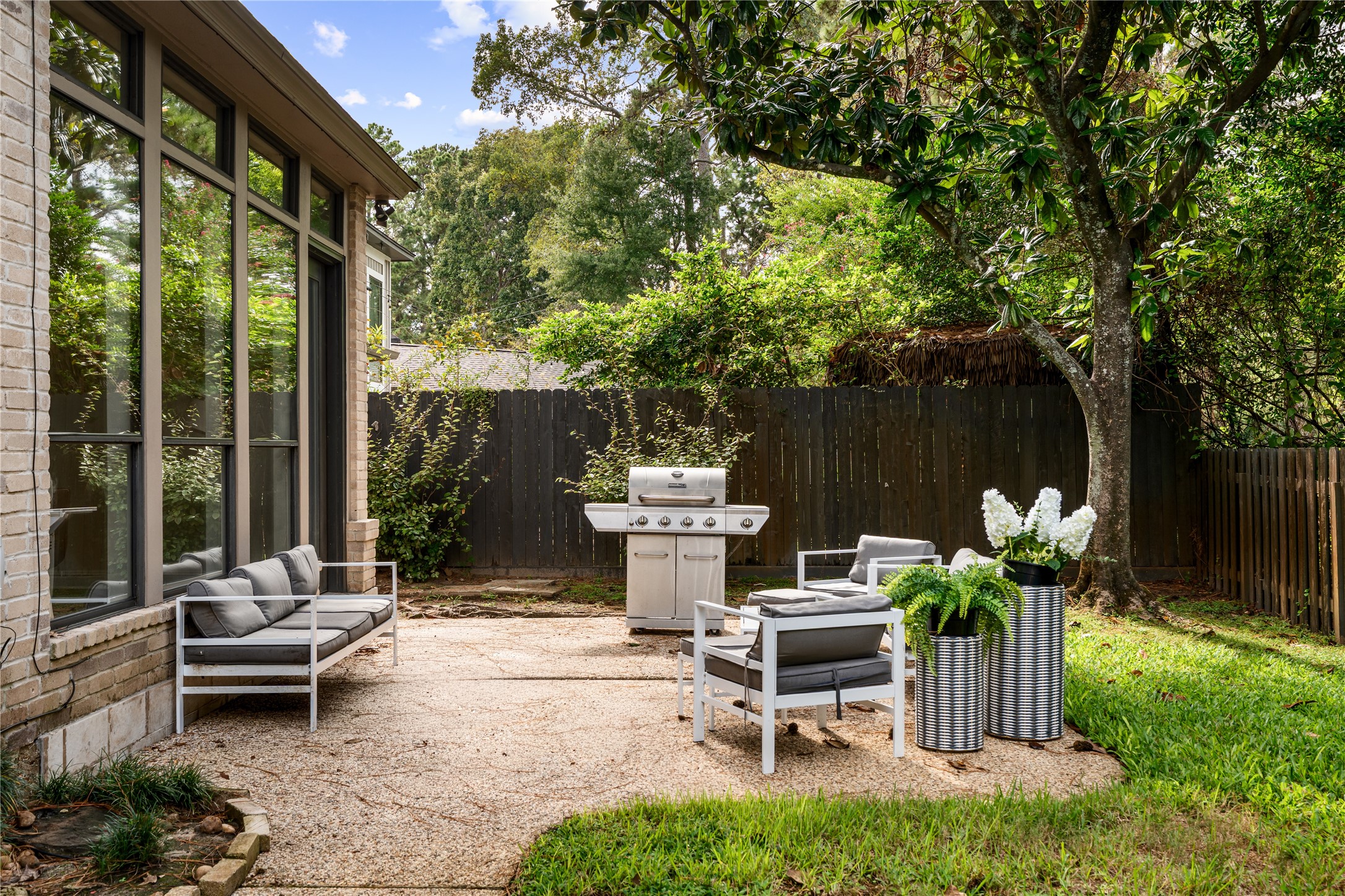 An inviting outdoor sitting area perfect for grilling, relaxing, and gathering with friends, conveniently located just steps from the kitchen and home office.