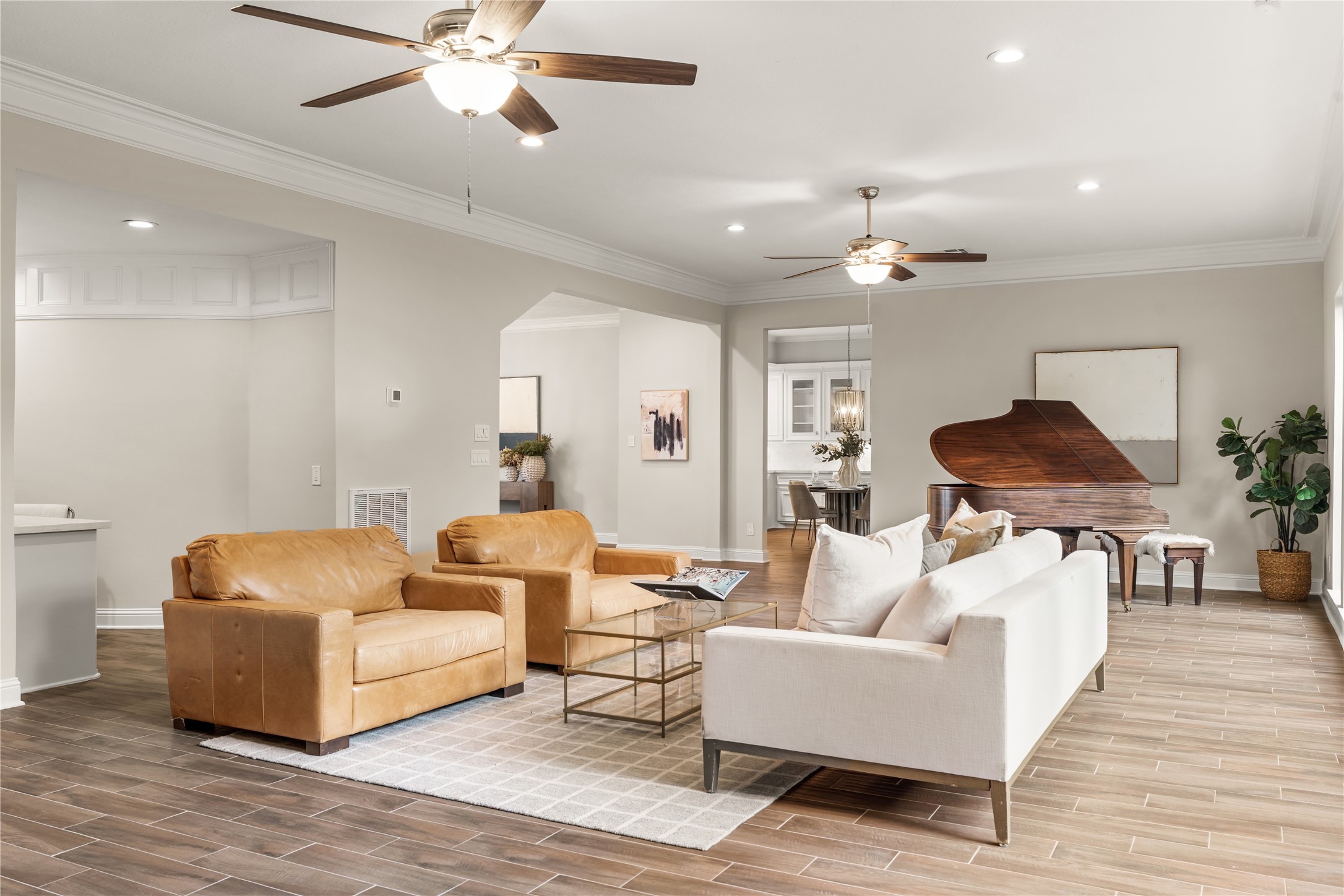 The open-concept layout creates an effortless flow between the homes gathering spaces, while a thoughtfully positioned office nook in the corner adds a discreet and functional workspace without interrupting the rooms elegant design.