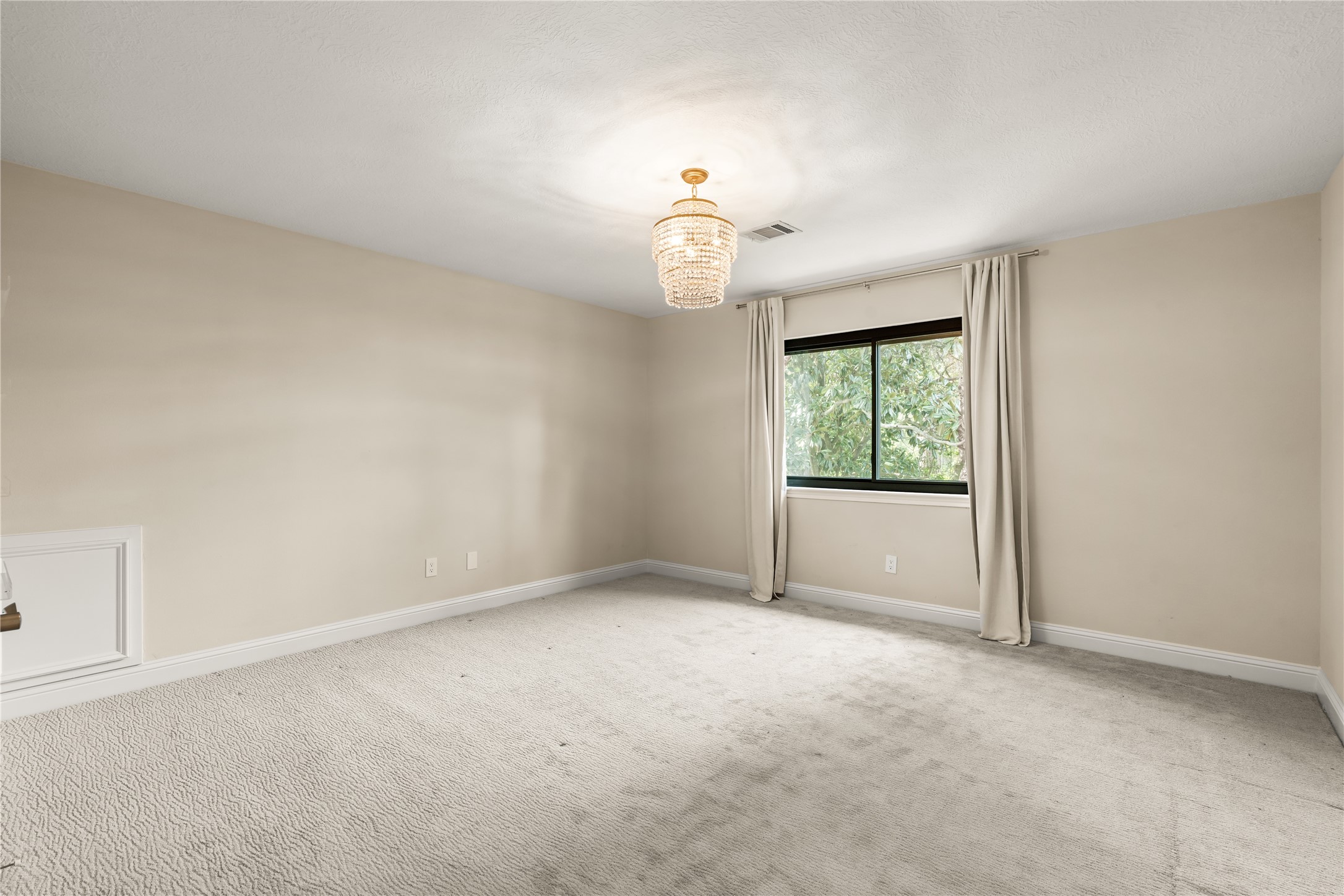 This inviting secondary bedroom offers generous proportions, soft natural light, and a serene neutral palette ready to complement a variety of styles.