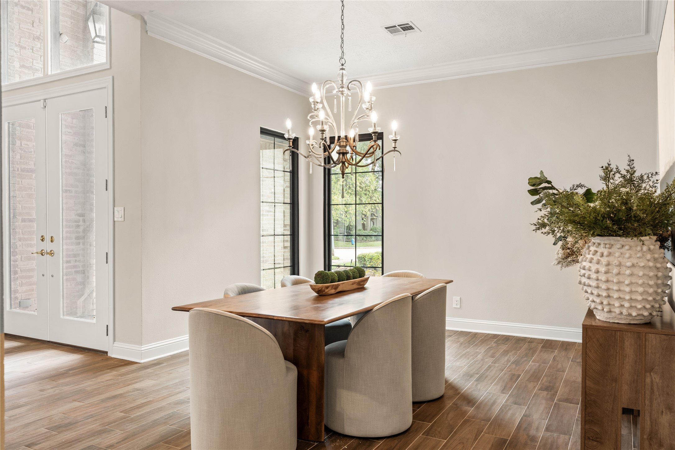 Refined yet inviting, the formal dining room pairs warm wood tones, elegant lighting, and tall windows for a sophisticated entertaining setting.