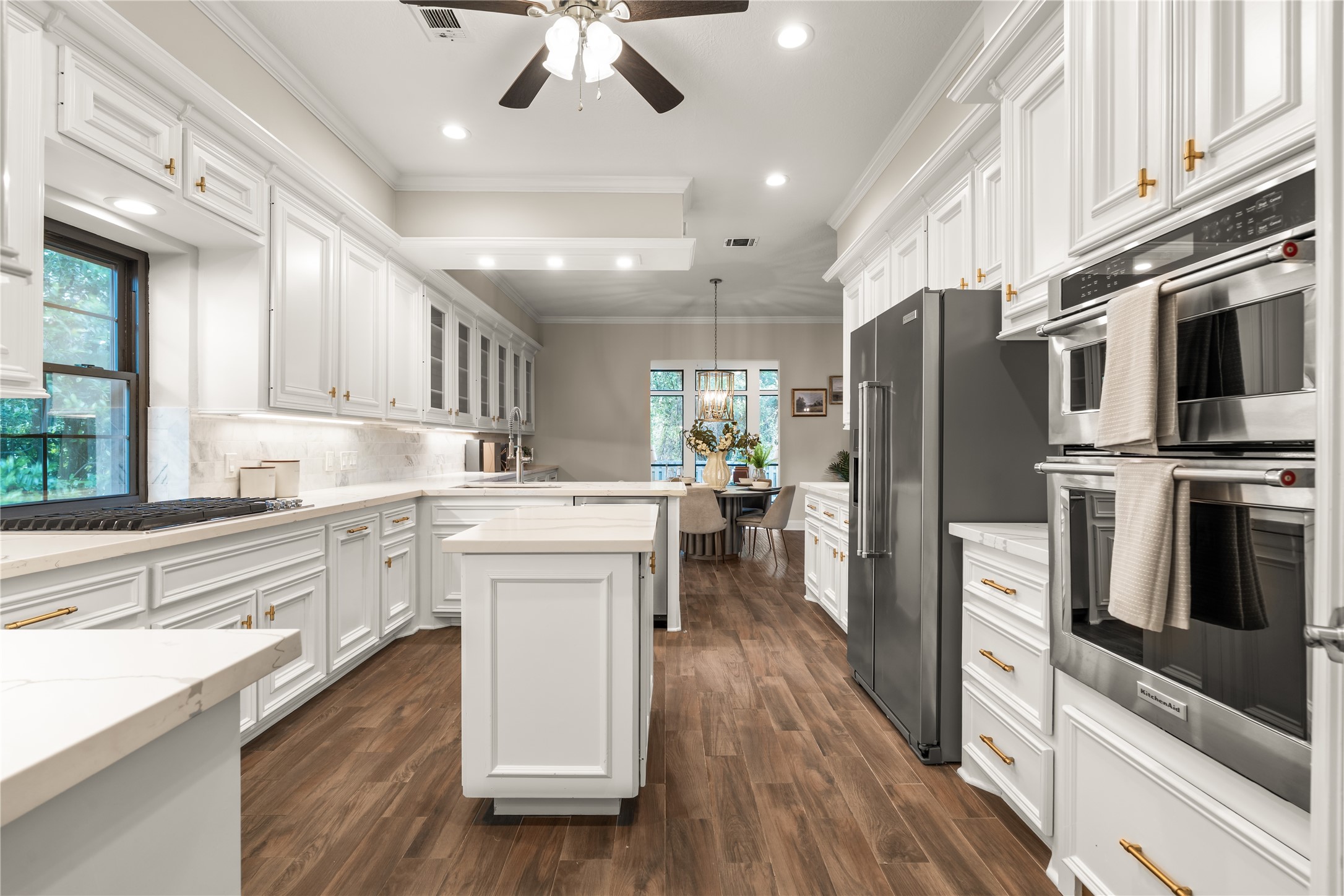 Designed with the home chef in mind, this well-appointed kitchen features double ovens, expansive quartz countertops, and a window above the sink that fills the space with beautiful natural light.