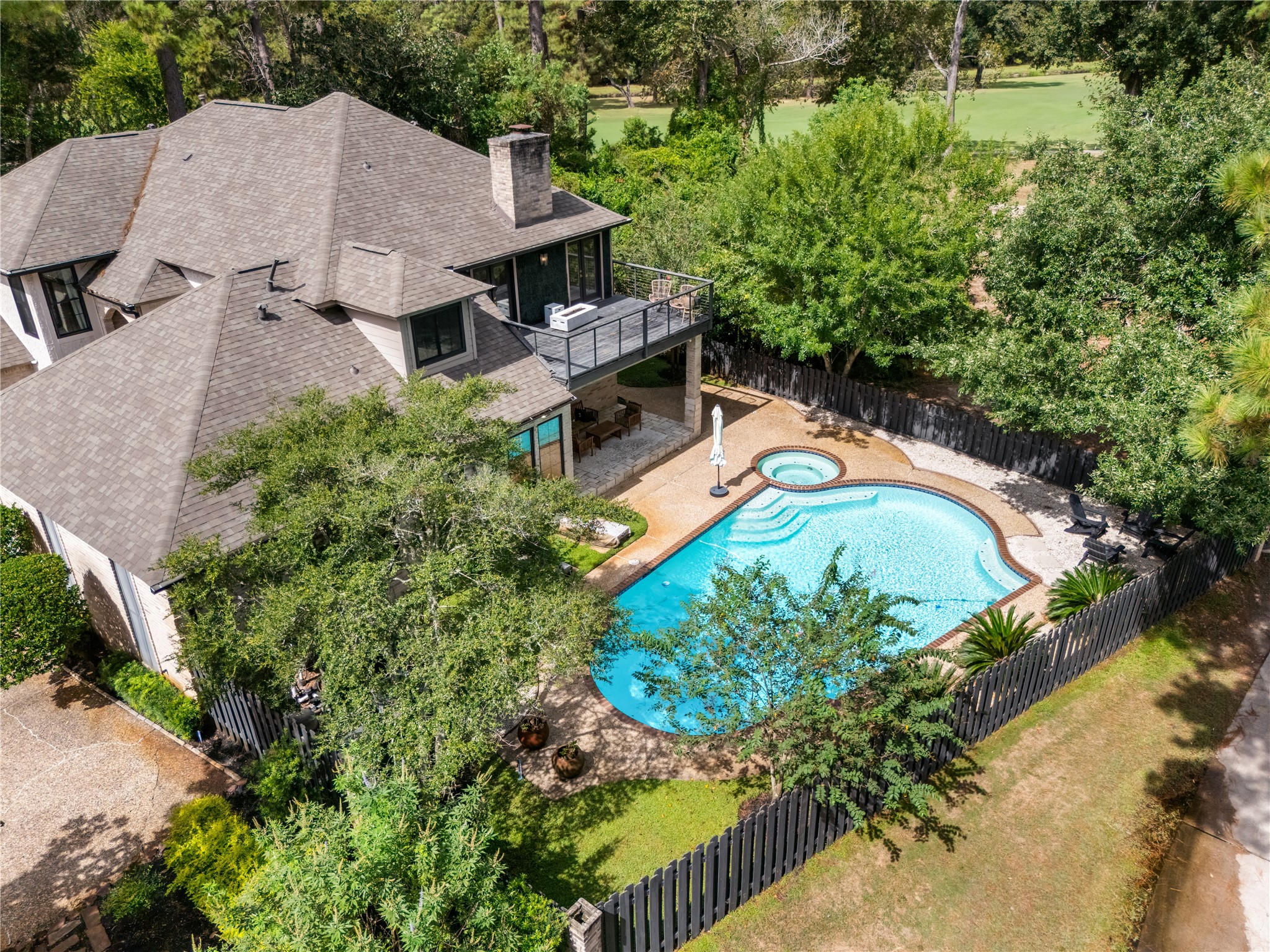 The backyard flows directly to the Deerwood Country Club golf course, creating a coveted setting where private outdoor living meets the beauty of the fairways. The pool, spa, covered patio, and elevated terrace make the most of this exceptional golf-course location