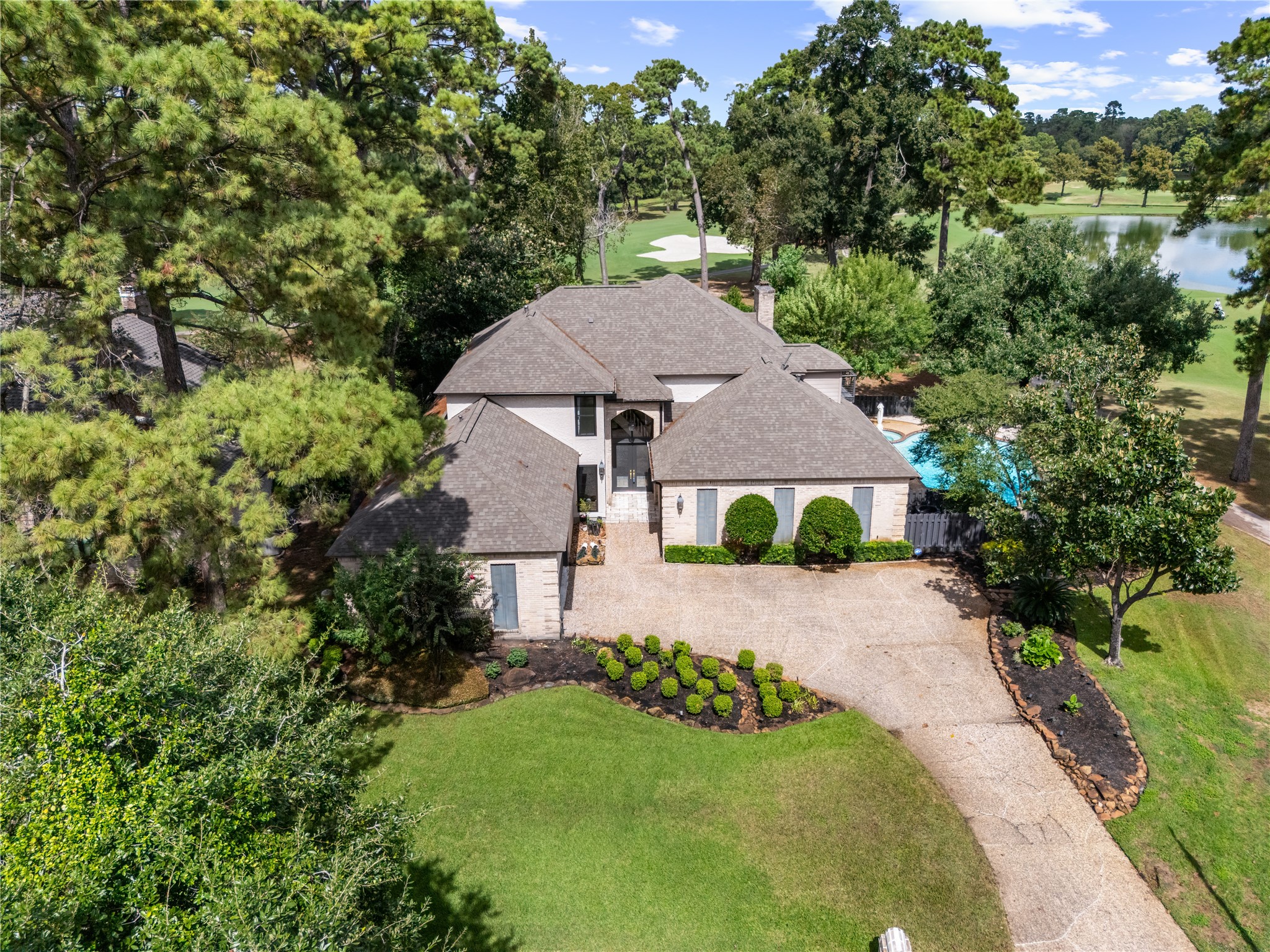 An exceptional setting elevates this residence, ideally positioned along the golf course with tranquil water views and lush greenery creating a private, resort like backdrop.