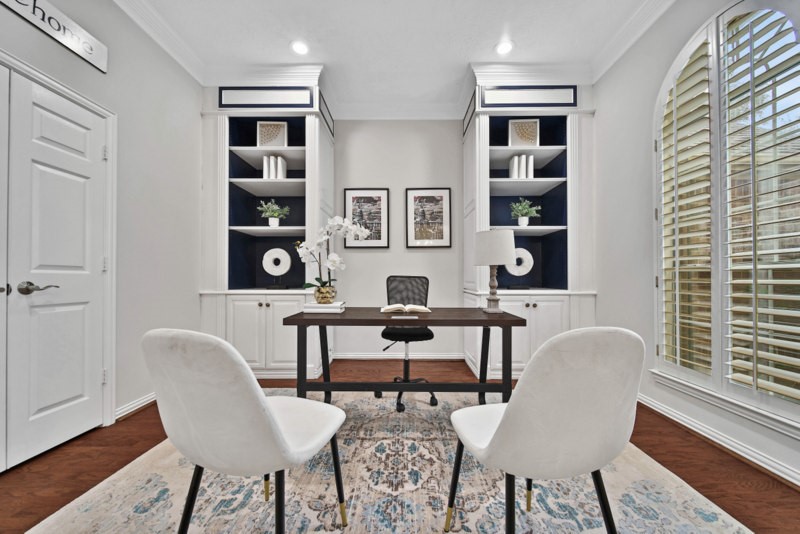 The view of home office/study W/Built-in bookshelves, plantation shutters. The view of home office/study W/Built-in bookshelves, plantation shutters.