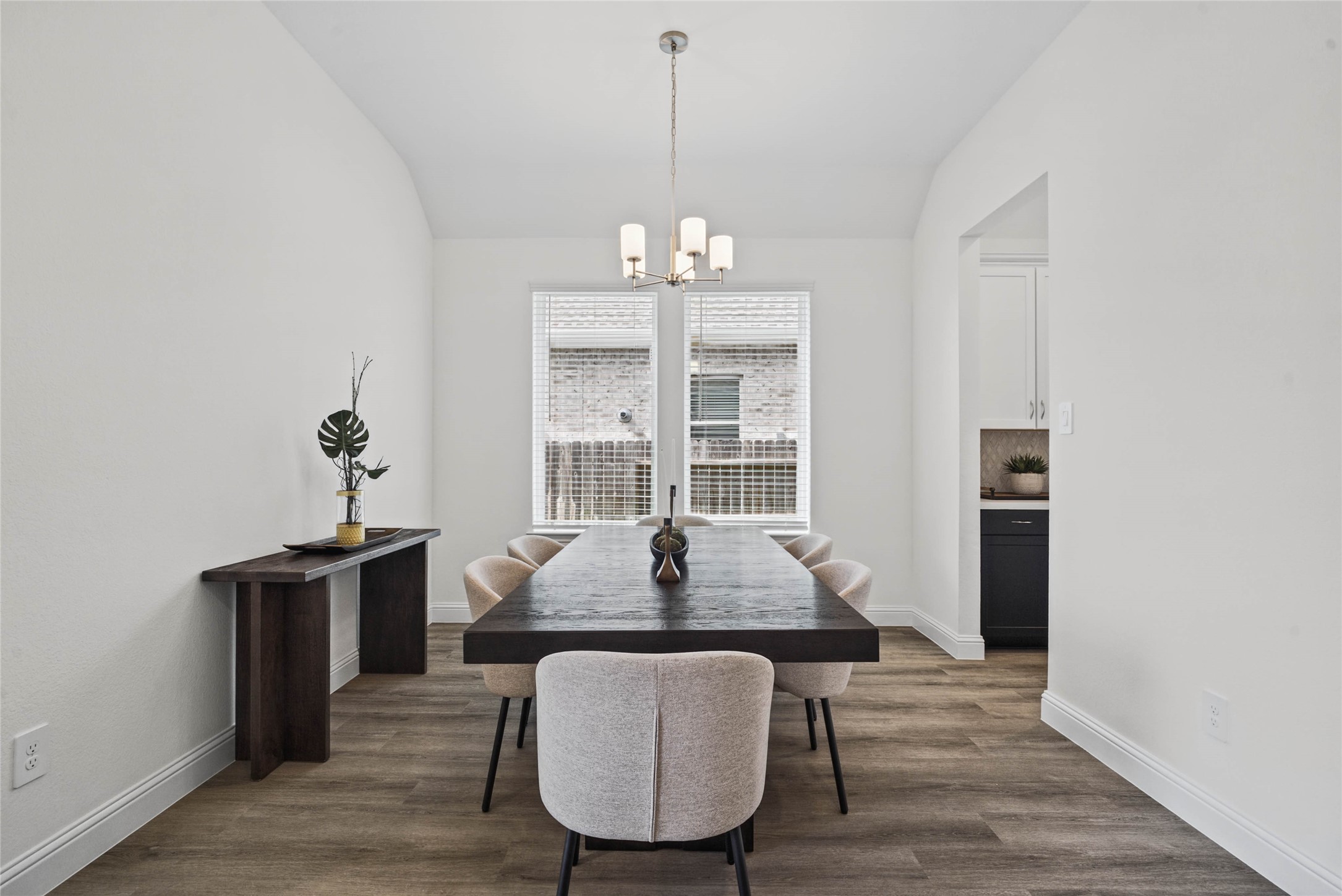 You and your guests will certainly dine in style in this amazing formal dining room! Featuring a gorgeous modern chandelier, large window with blinds, neutral paint, high ceilings, and luxury vinyl flooring! Perfect space to entertain family and friends!