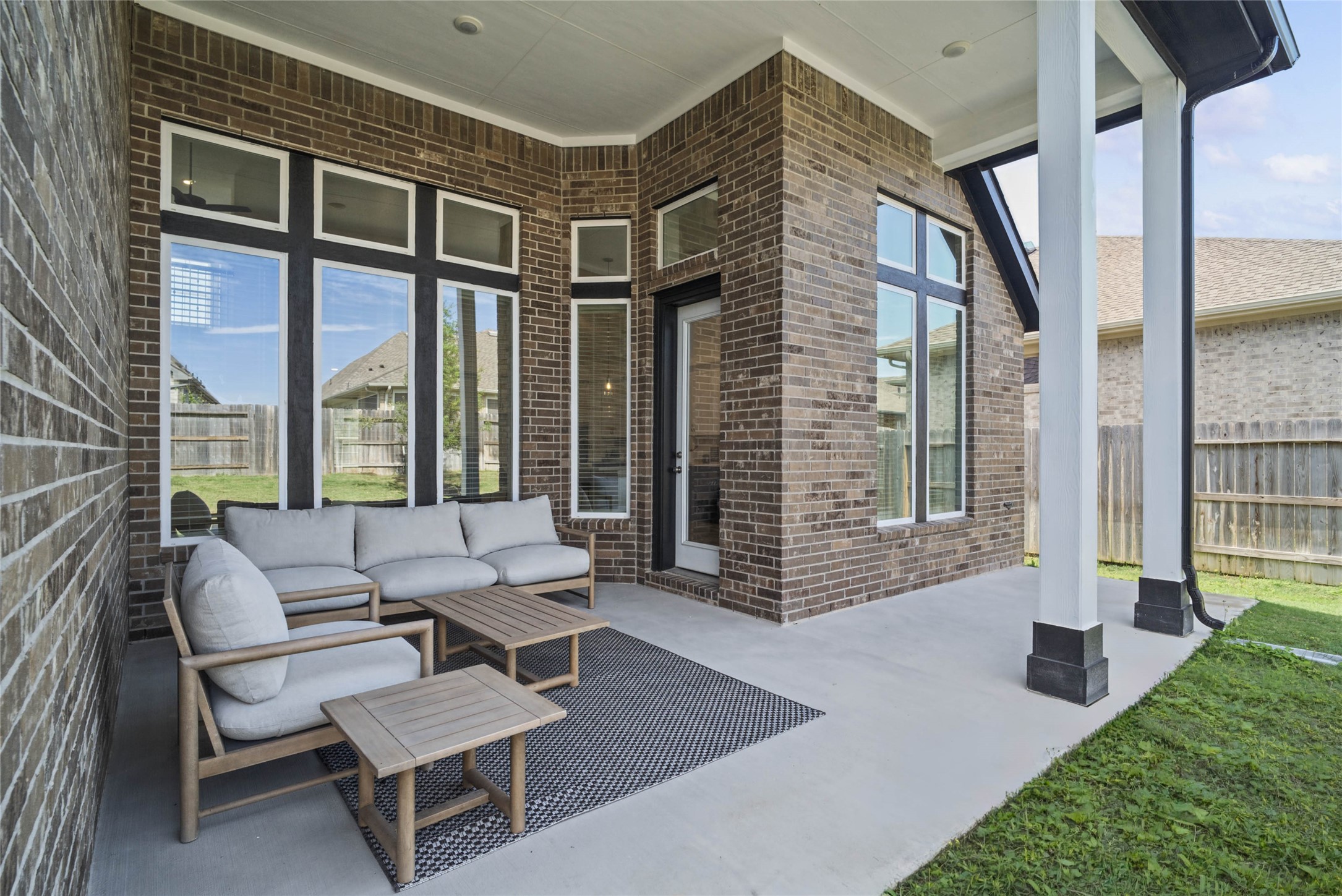 Step outside to the covered rear patio, the perfect extension of your indoor living space for year-round enjoyment.