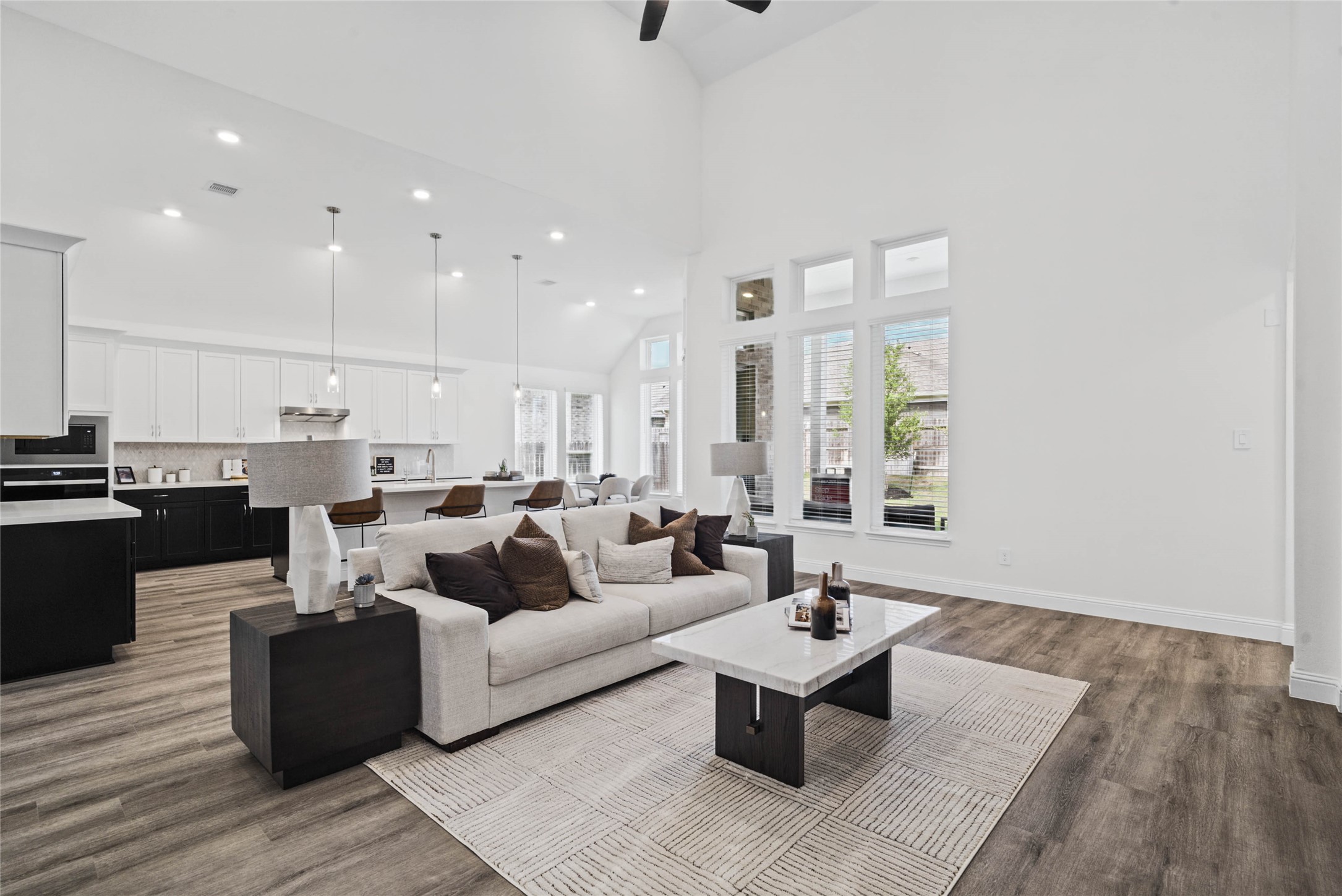 Enjoy the open and airy Family Room, designed for seamless entertaining and showcasing striking architectural details with high ceilings and durable flooring.