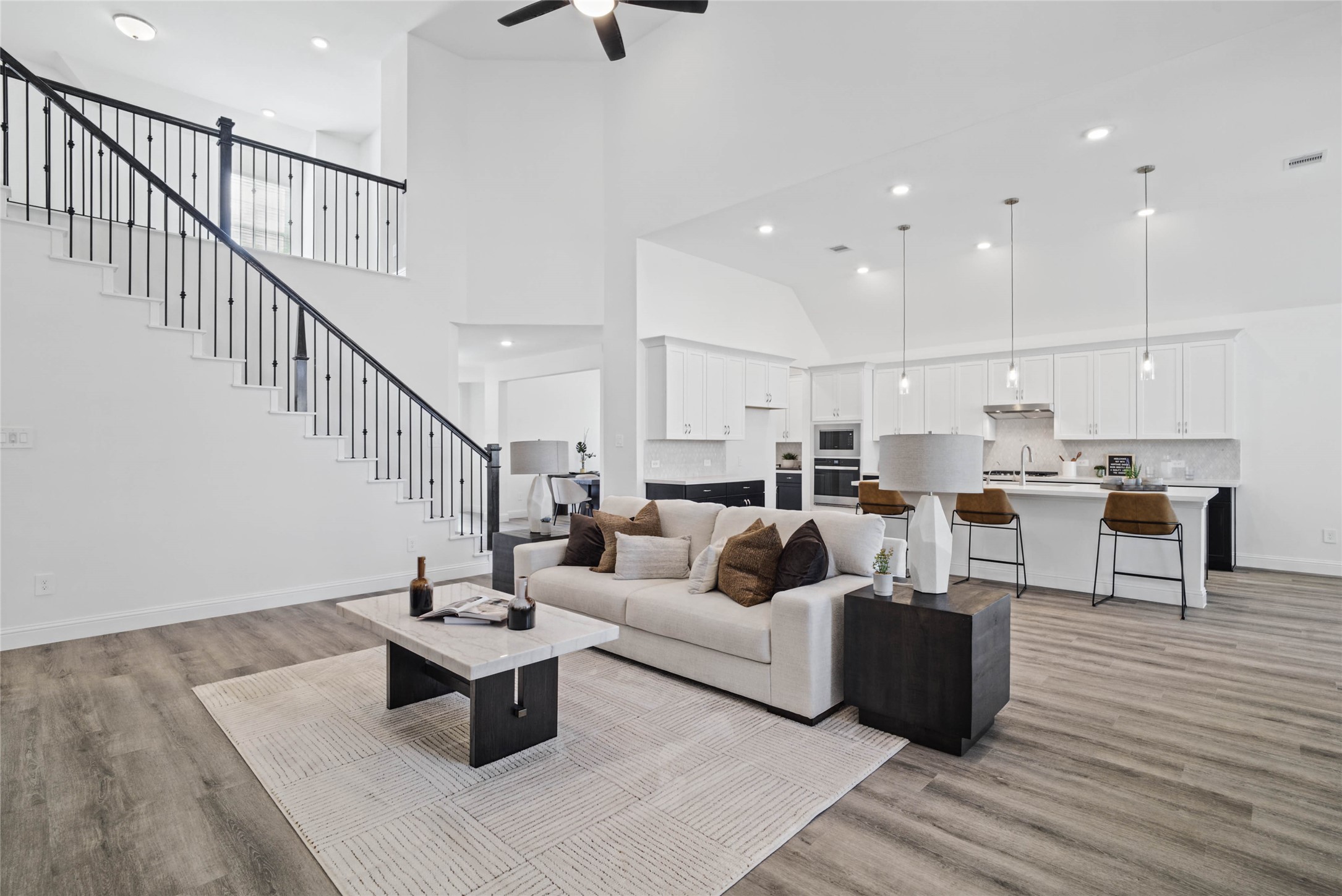 Open concept living space connecting the family, kitchen, breakfast nook and overlooking views of the second floor landing.