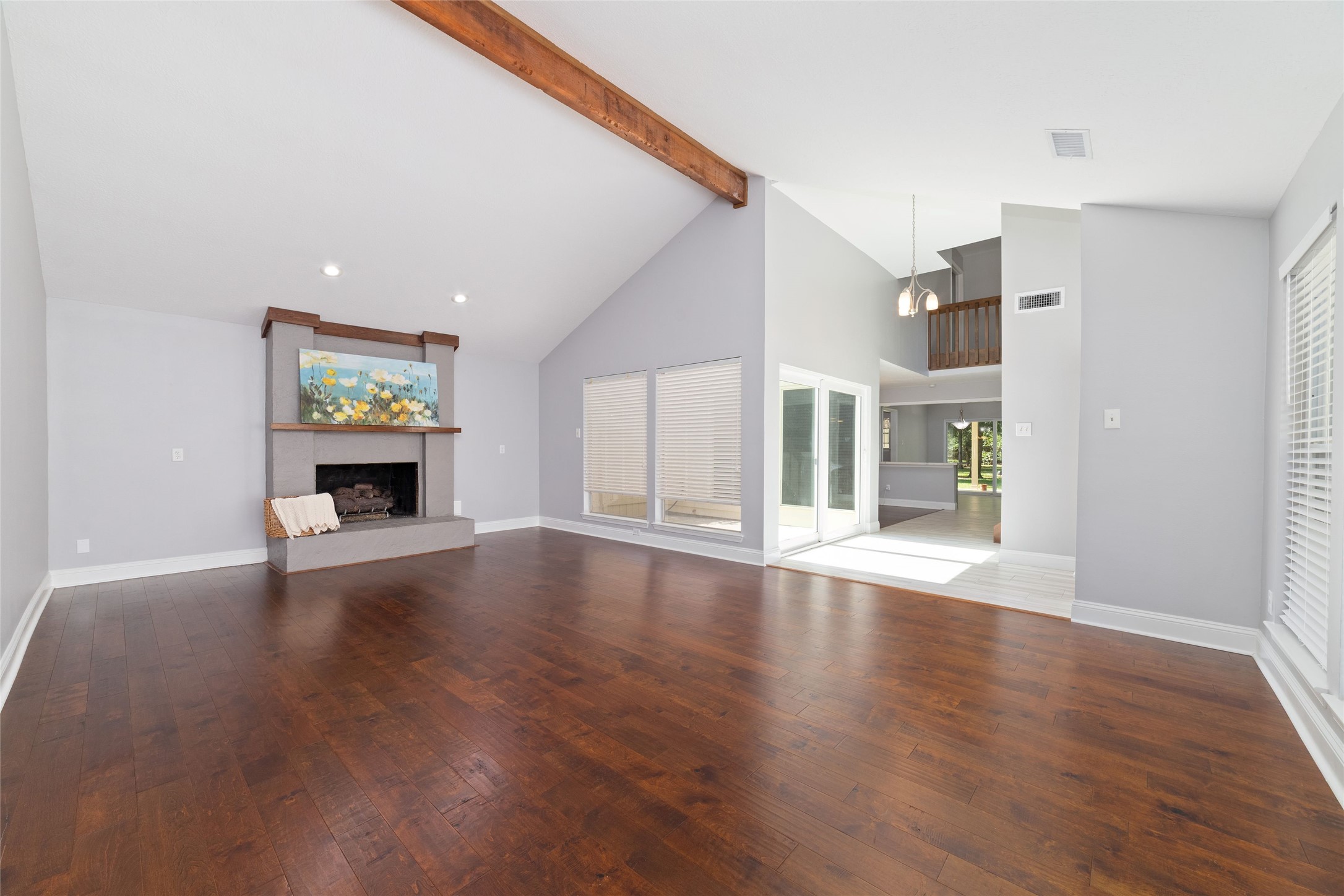 Another view of the spacious Living Room reveals the home's distinctive architectural design. An oversized sliding glass door opens to a private courtyard, while walls of windows connect the Living and Dining Rooms visually through the outdoor space, creating a wonderful indoor-outdoor relationship and filling the home with natural light.