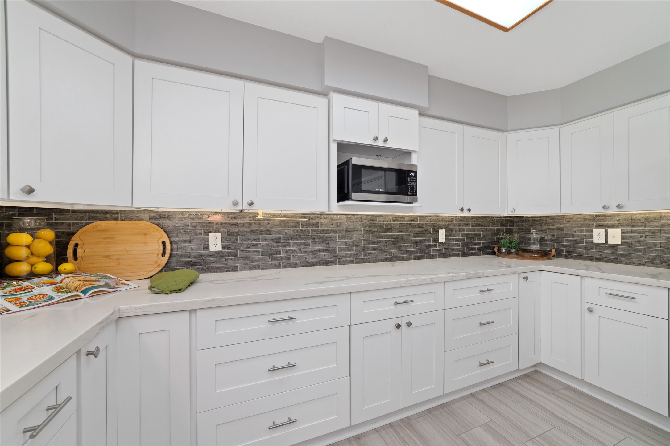 A kitchen designed for those who love to cook! Generous quartz countertops provide plenty of room for meal preparation, while abundant cabinetry, deep storage drawers, and convenient pull-out shelving keep everything organized and within reach. Undercabinet lighting adds both beauty and function to this thoughtfully remodeled space.