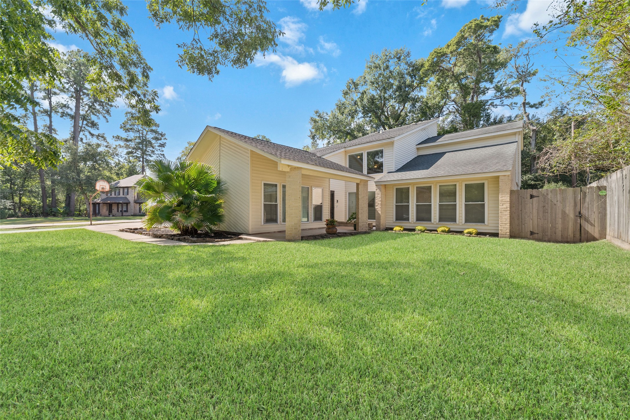 A closer look at the home's distinctive architecture and expansive windows that fill the Living Room and Primary Bedroom with natural light. Energy-efficient double-pane replacement windows are among the many thoughtful improvements made to this beautifully maintained home.