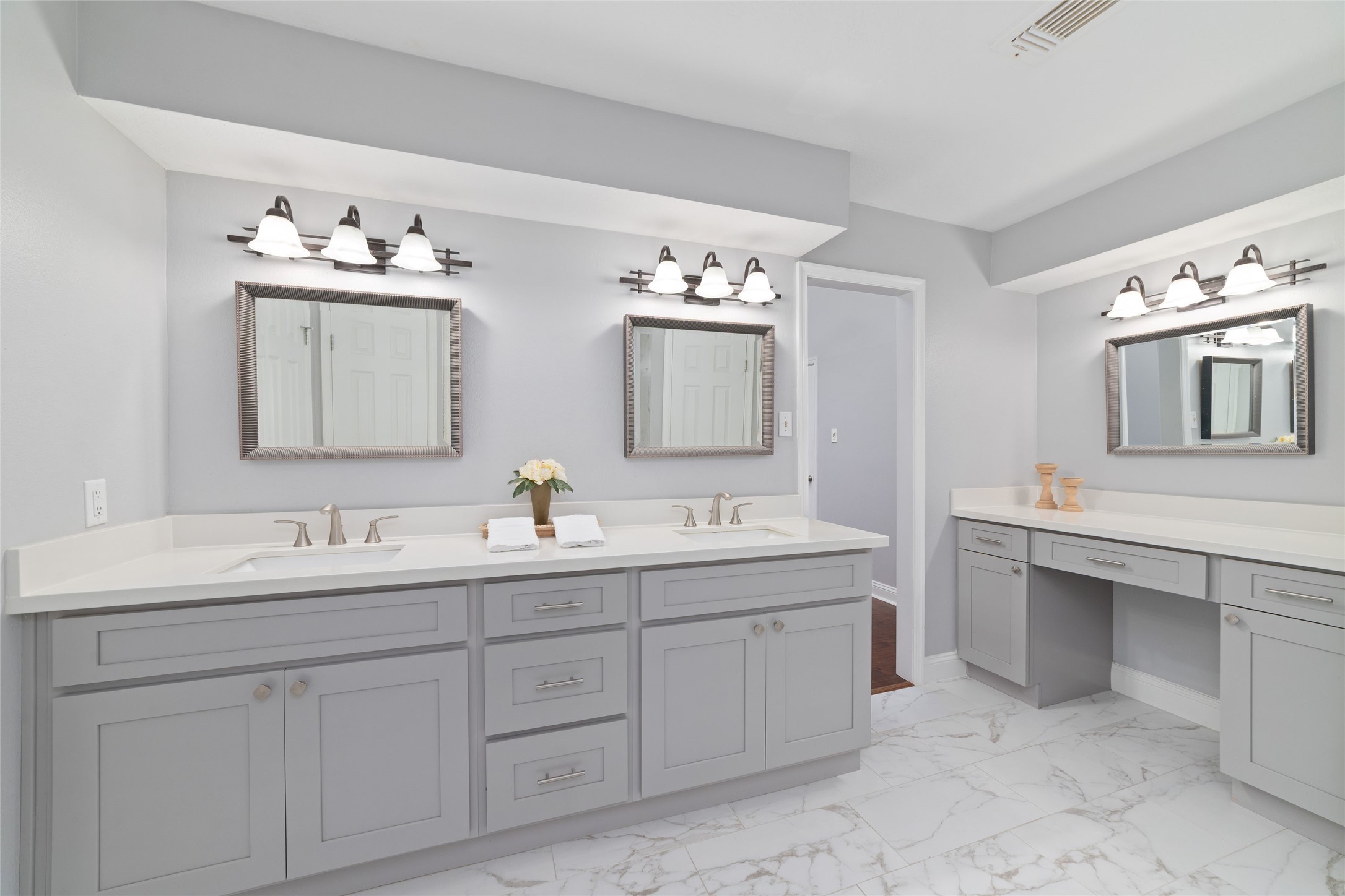 A little extra room to begin and end your day! This spacious Primary Bath features separate sinks, an oversized vanity with abundant cabinet and drawer storage, plus a dedicated makeup vanity. Soft, neutral finishes create a fresh, inviting atmosphere, while separate walk-in closets offer plenty of personal storage.
