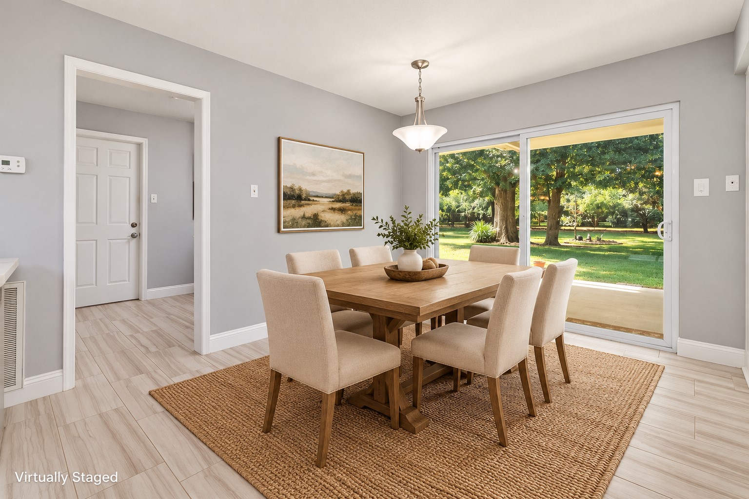 Imagine starting your mornings with coffee and a beautiful view of the backyard! This spacious Breakfast Room offers plenty of room for everyday dining, while oversized sliding glass doors open to the large covered patio and expansive, tree-shaded lawn. A wonderful place to gather for meals, enjoy the changing seasons, and make everyday moments feel special.