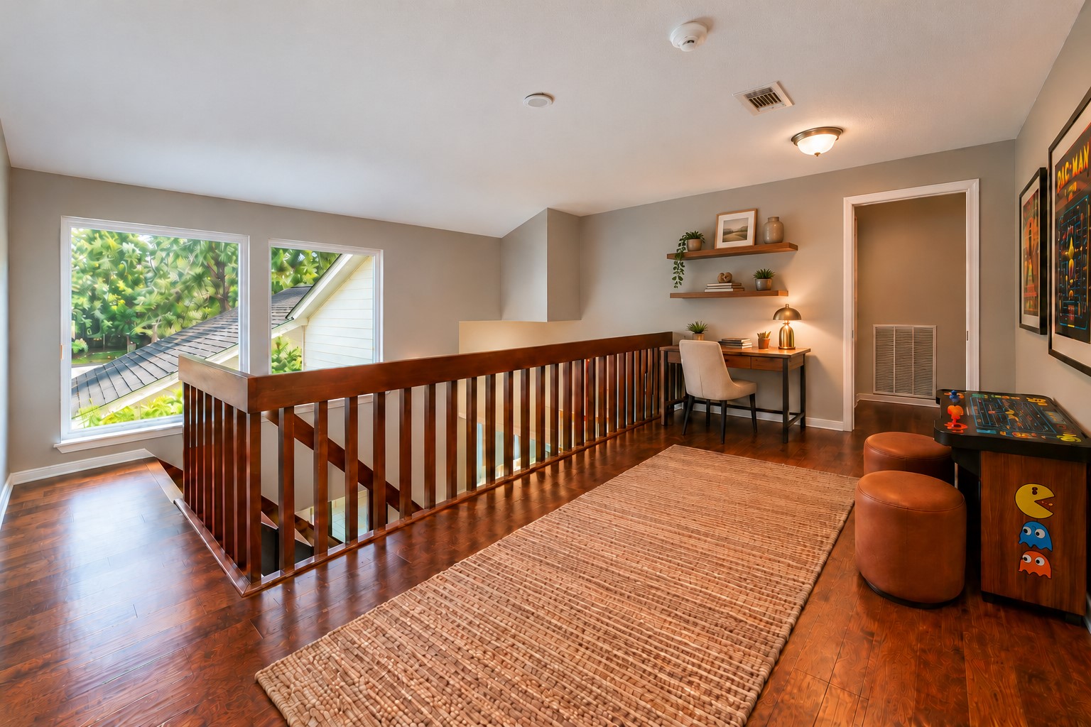More than just a landing! This spacious upstairs loft area offers room for a homework station, gaming nook, or cozy reading retreat. Large windows bring in natural light, while beautiful wood floors and an open staircase connect the home's two levels.