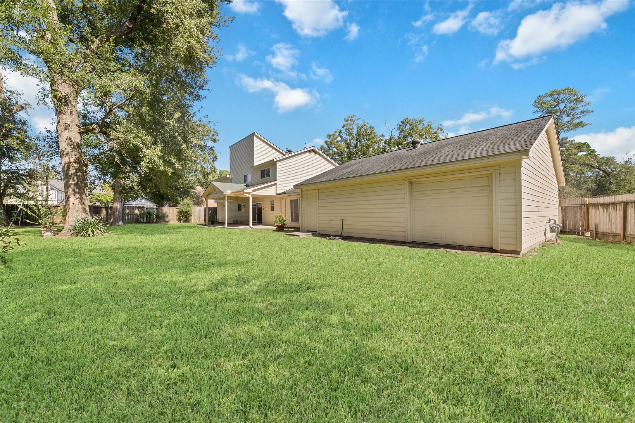 More than just a place to park! The oversized garage features a convenient rear roll-up door providing direct access to the backyardperfect for moving lawn equipment, gardening supplies, or outdoor projects in and out with ease. Open both the front and rear garage doors to enjoy refreshing cross-ventilation while working on hobbies or weekend projects