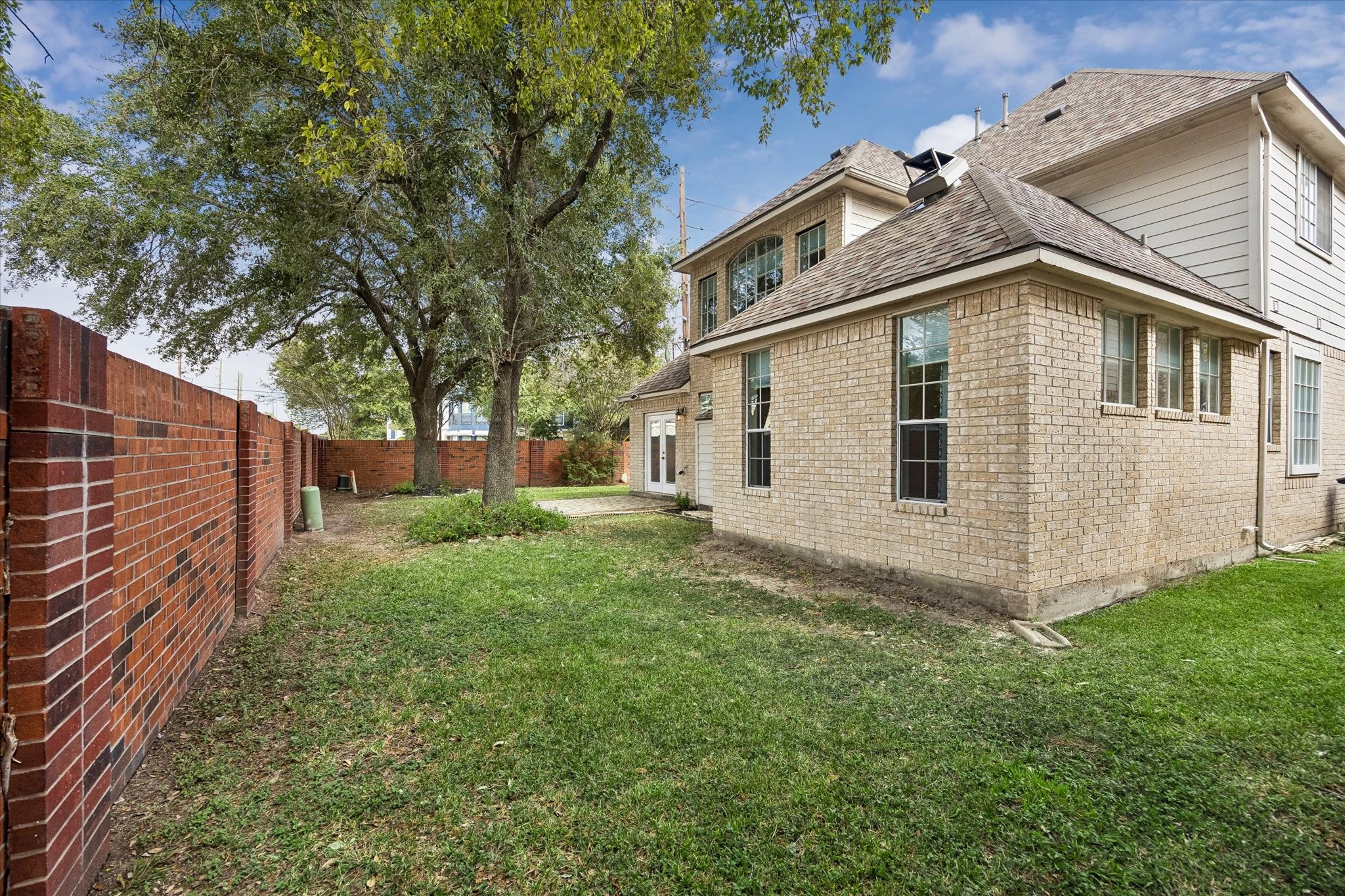 The back yard area with the attractive brick wall surrounding the property.