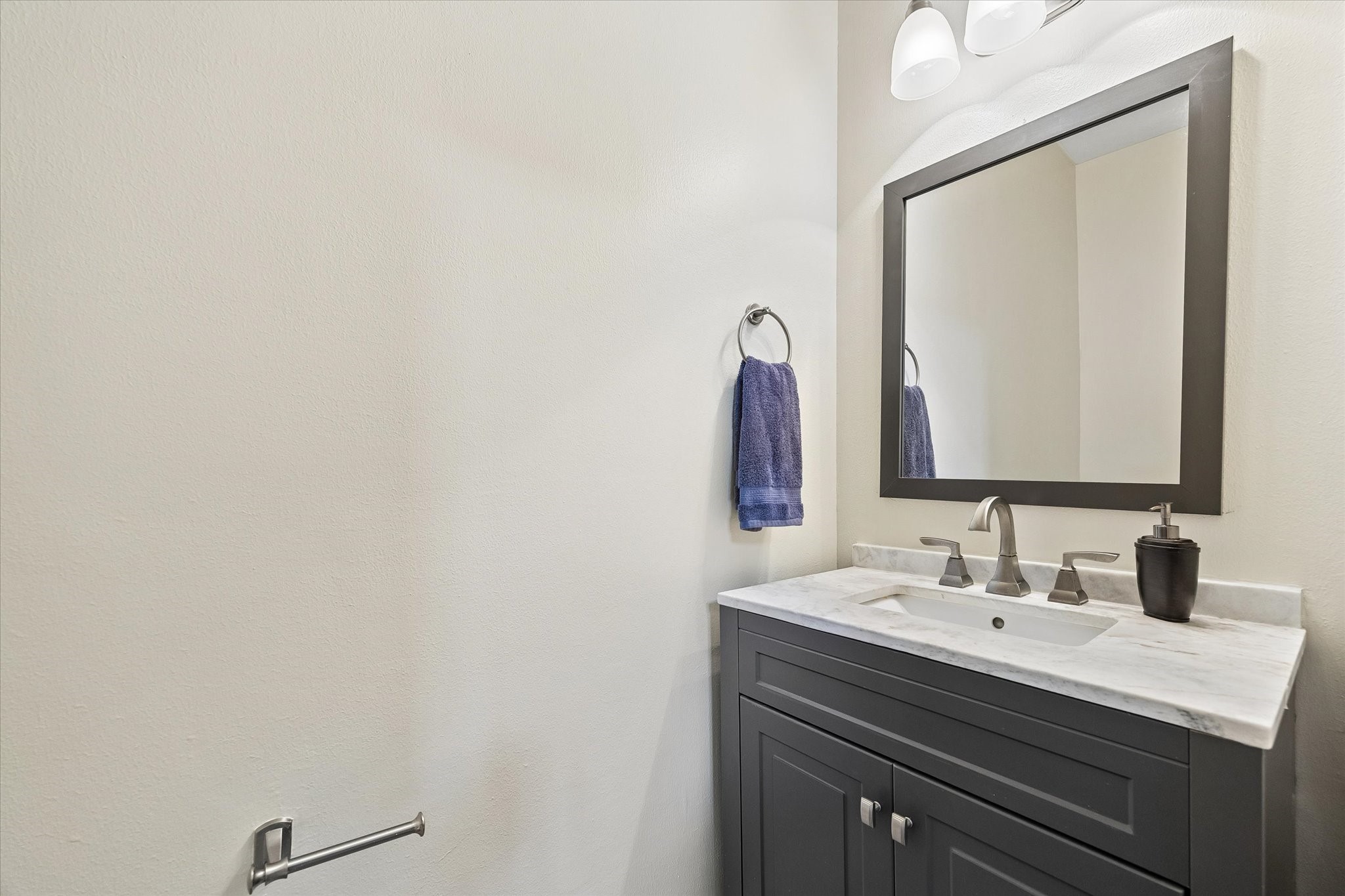 Half Bath off of the main hallway downstairs.