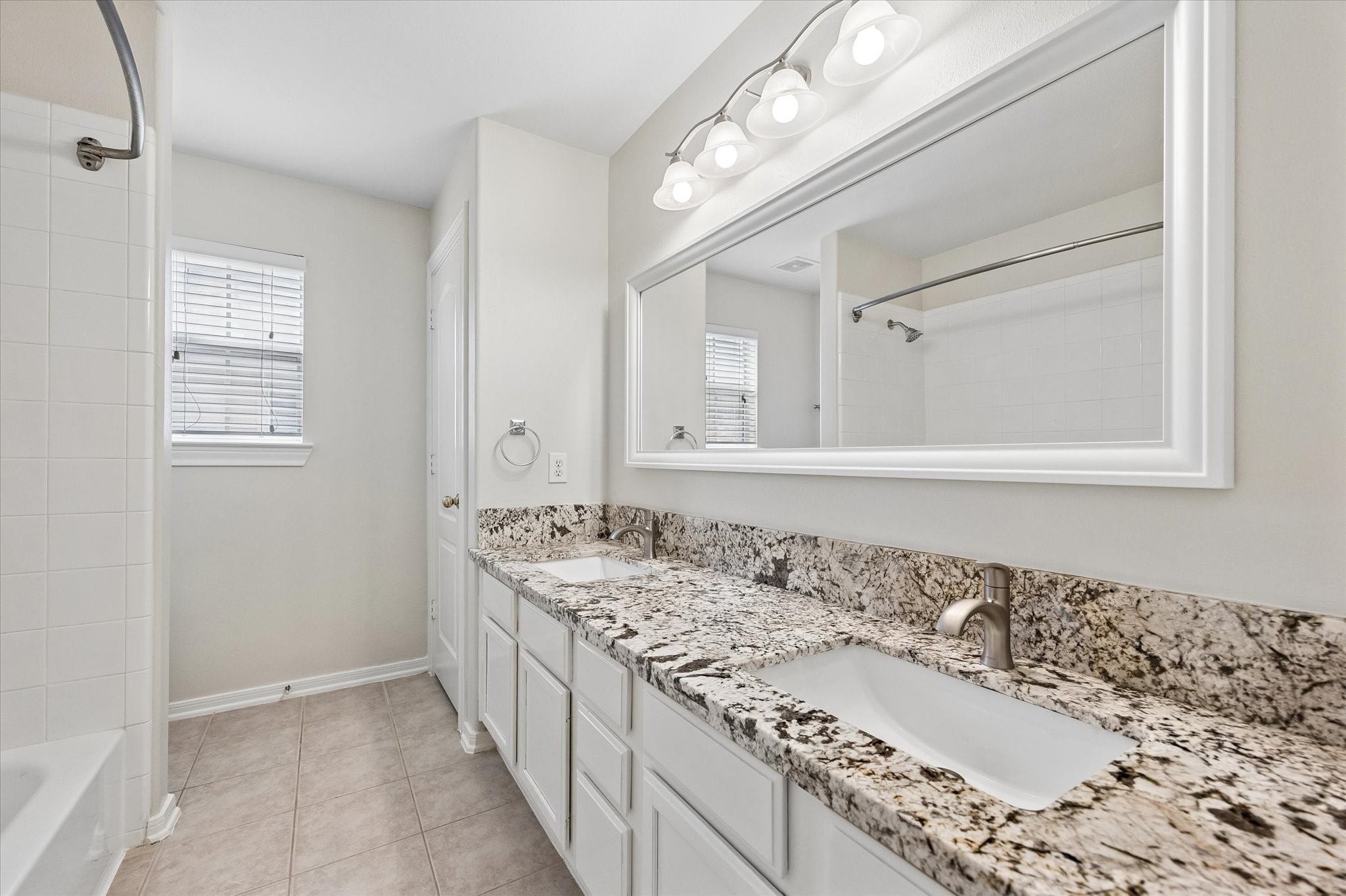 Upstairs Bath with double sinks and tub/shower.