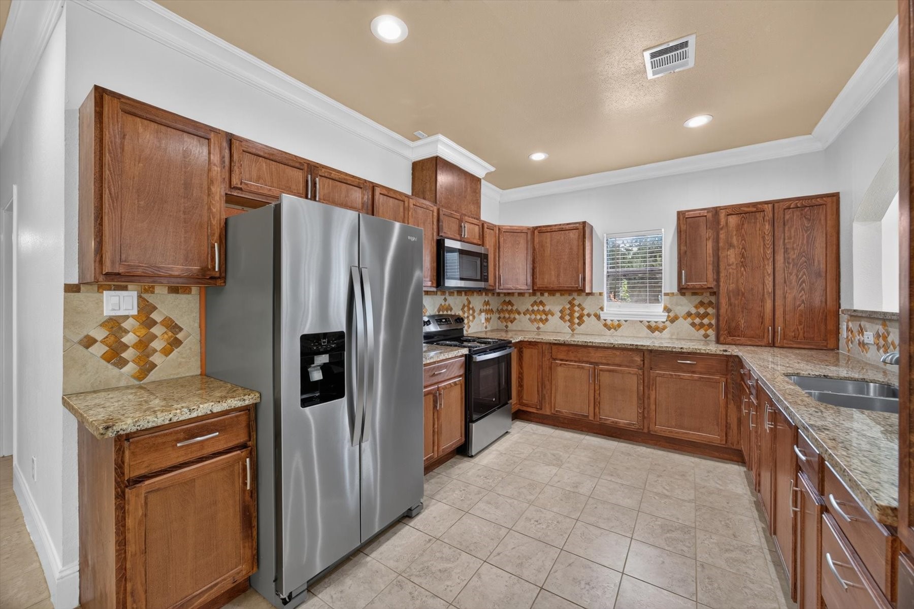 Kitchen with Stainless Steel Appliances & Custom Cabinetry Kitchen with Stainless Steel Appliances & Custom Cabinetry