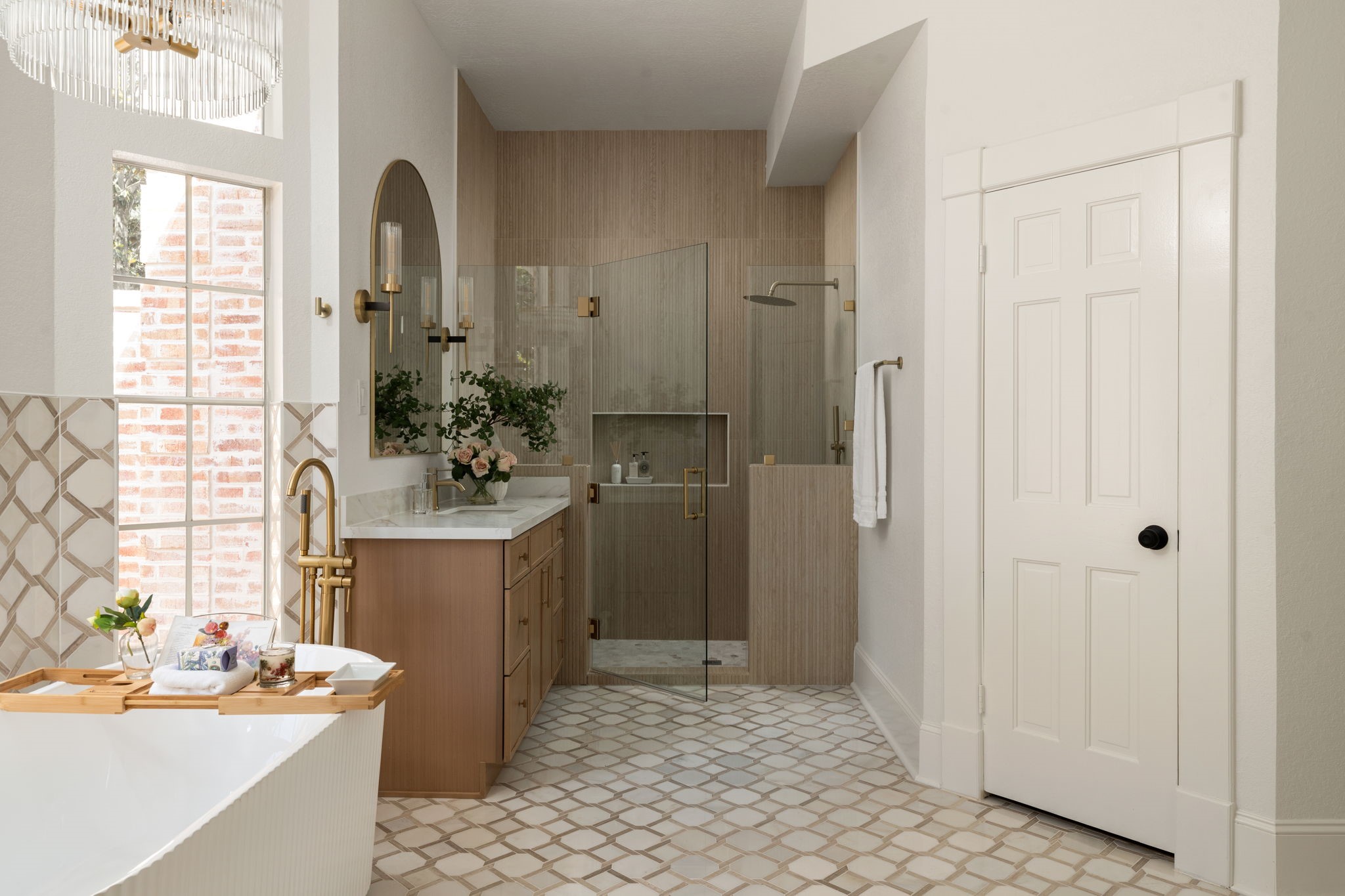 The primary bath combines oversized proportions with a functional layout designed for everyday comfort and privacy. A frameless glass shower, freestanding soaking tub, and extensive vanity storage enhance the rooms livability. Positioned nearby is one of two walk-in closets connected to the primary suite.