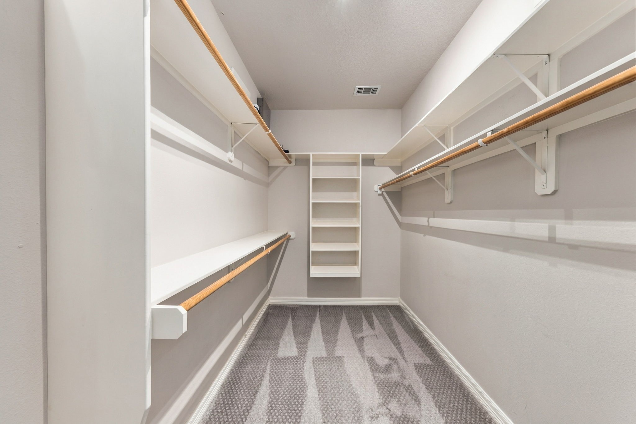 The Primary Bedrooms also features an oversized walk-in closet with double hanging rods, extensive shelving & plenty of room for wardrobe organization.