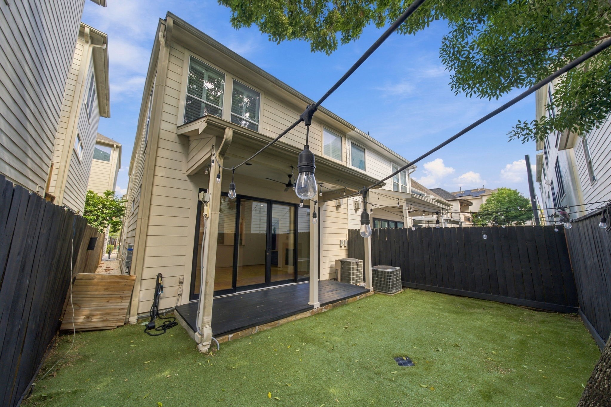 Another view of the private backyard, offering a wonderful balance of shaded patio space & easy-care turf for outdoor enjoyment.