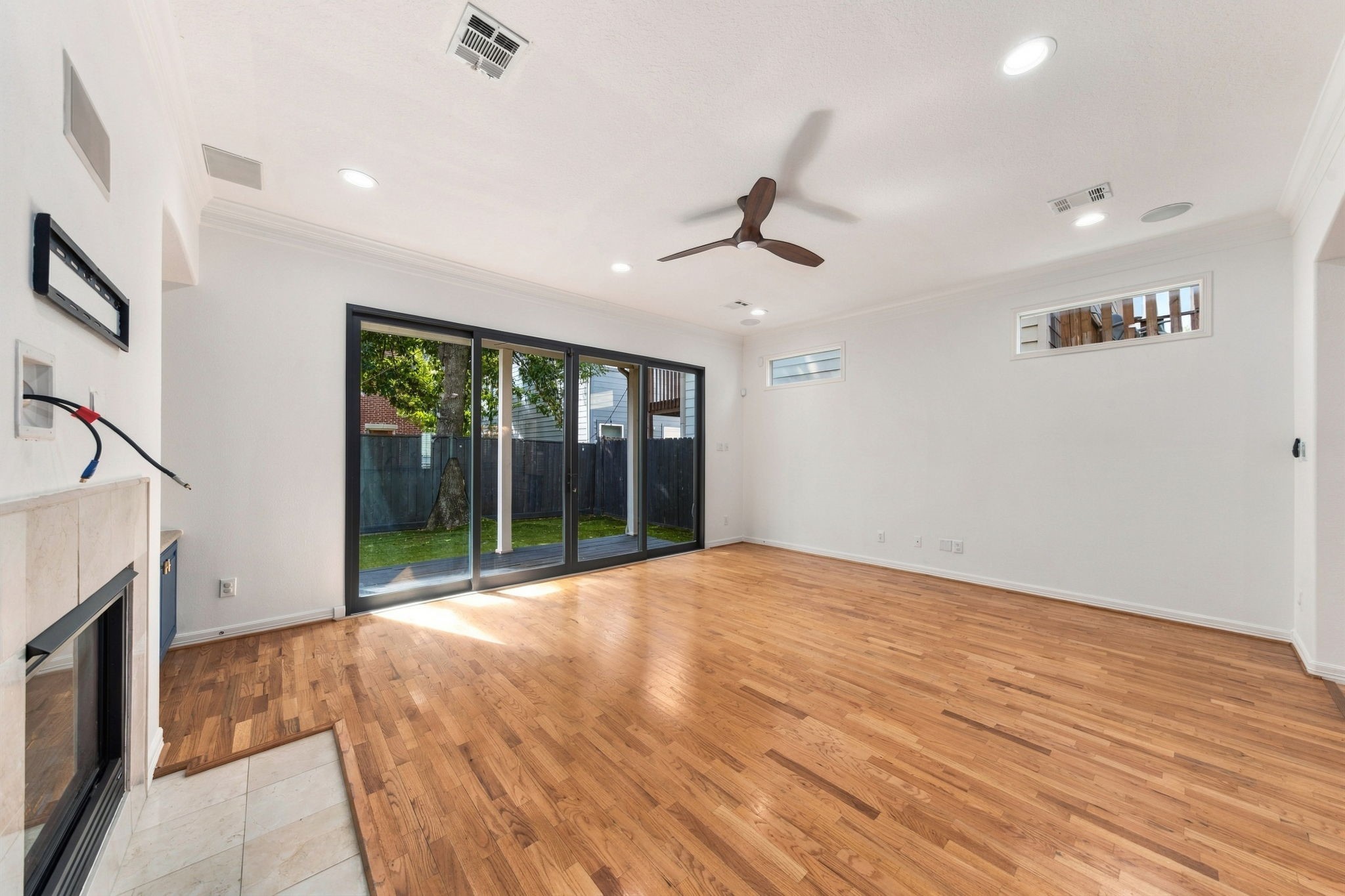 Another view of the living room, highlighting the natural light from the sliding glass doors and direct access to the covered patio & backyard.