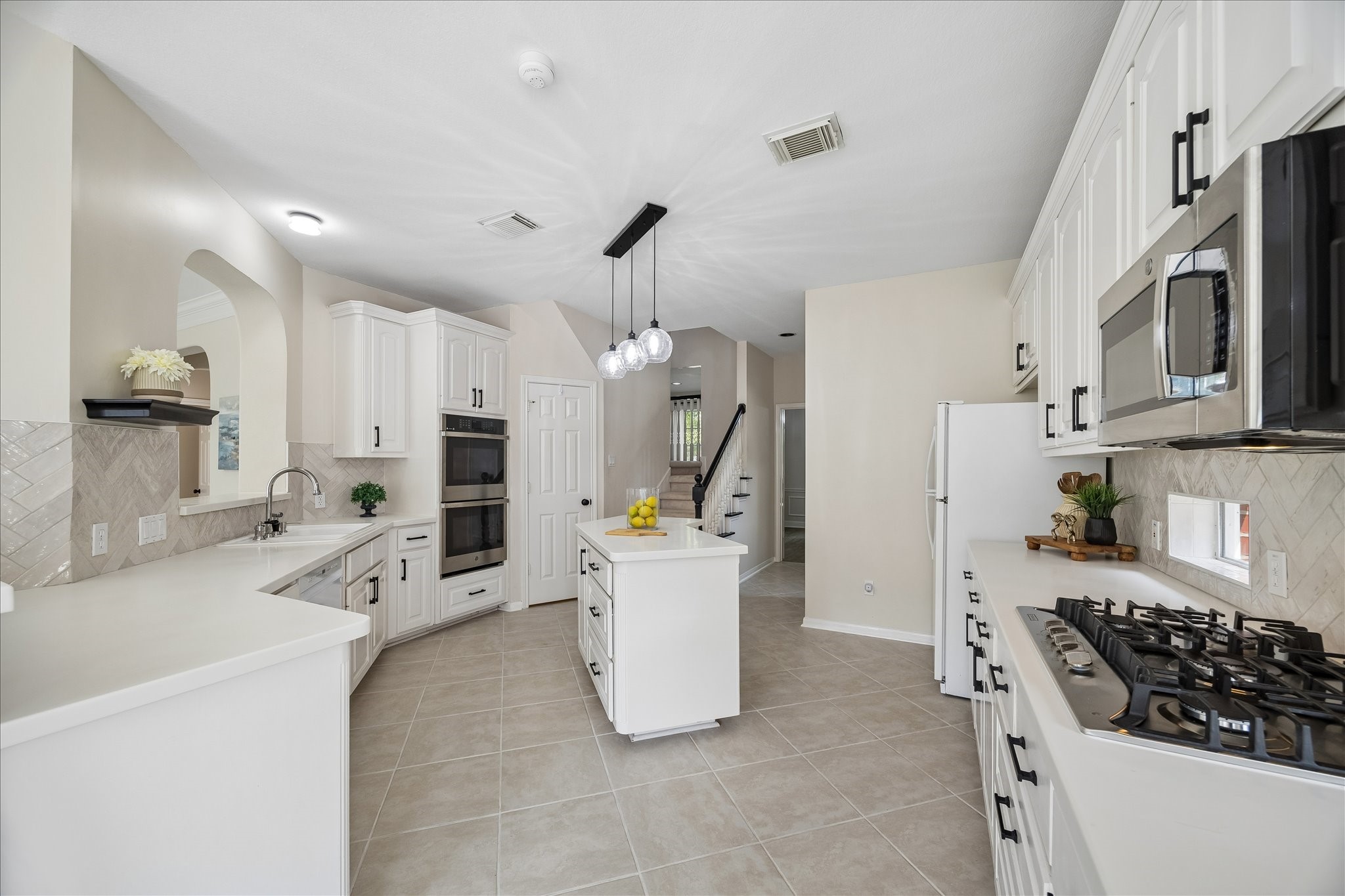 The beautifully updated kitchen features abundant cabinetry, generous prep space, and a functional center island designed for everyday living. An open layout keeps everyone connected while cooking and entertaining. The beautifully updated kitchen features abundant cabinetry, generous prep space, and a functional center island designed for everyday living. An open layout keeps everyone connected while cooking and entertaining.