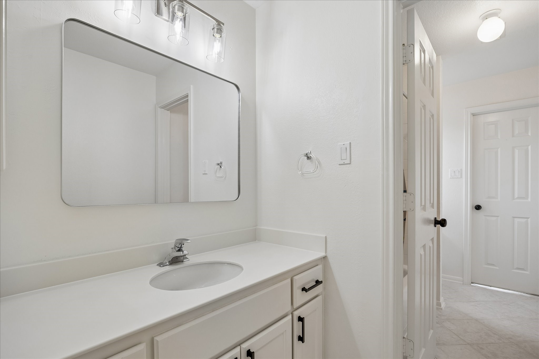 Clean lines and a neutral color palette provide a timeless backdrop that's ready for your personal style. The spacious vanity offers excellent storage and room to spread out.