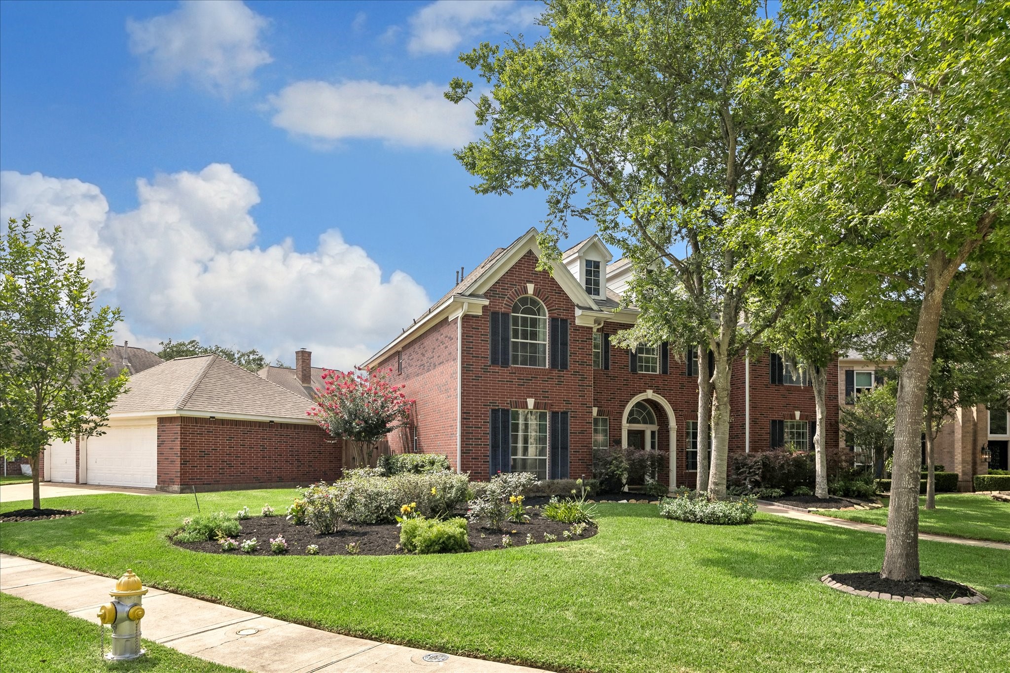 The expansive corner lot provides generous yard space and highlights the home's traditional architecture from every angle. Lush landscaping and a side-entry 3 car garage add to the home's curb appeal. The expansive corner lot provides generous yard space and highlights the home's traditional architecture from every angle. Lush landscaping and a side-entry 3 car garage add to the home's curb appeal.