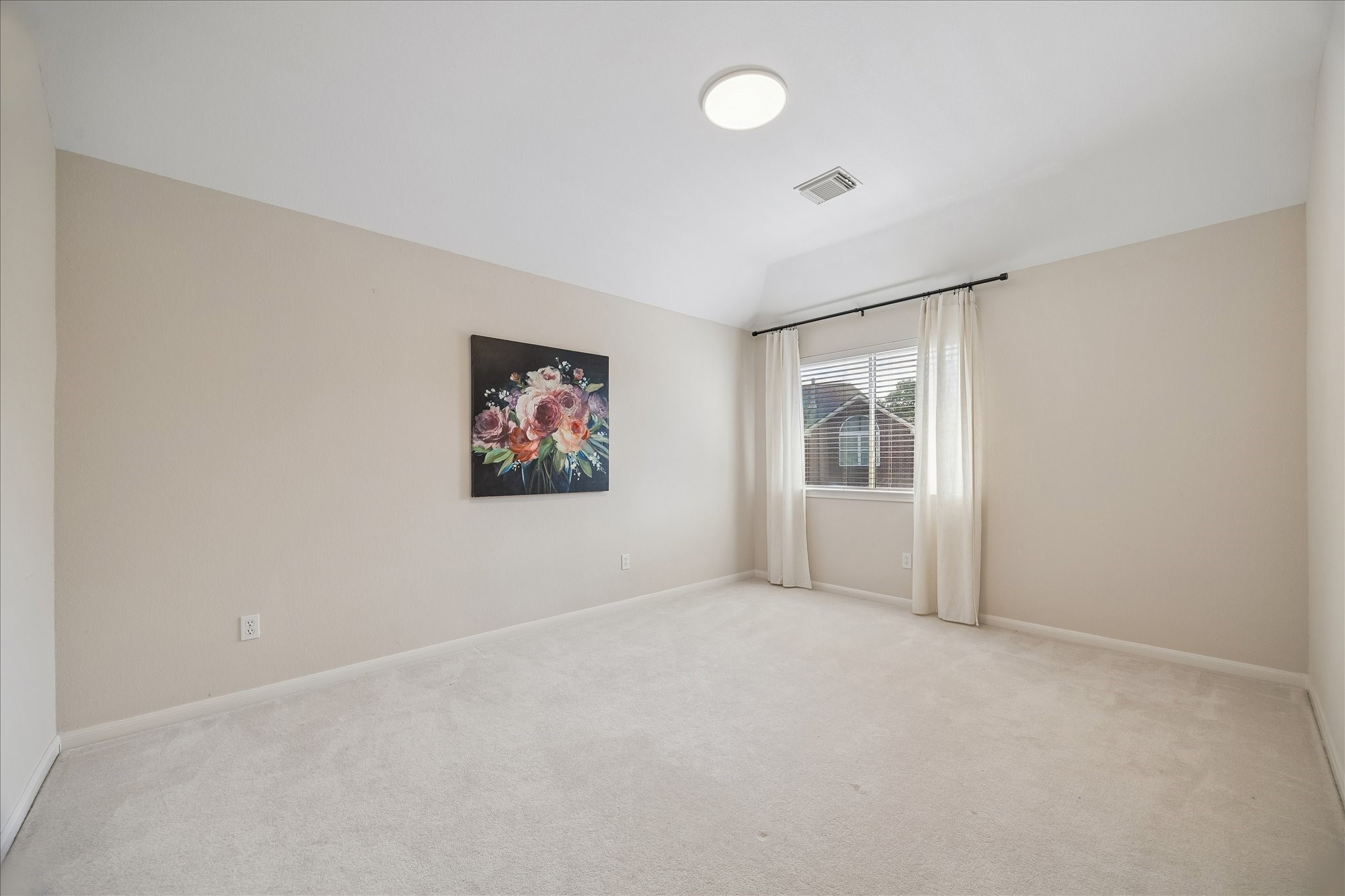 Bright and inviting, this secondary bedroom #4 offers neutral finishes and ample space for a variety of furniture arrangements to suit your needs.