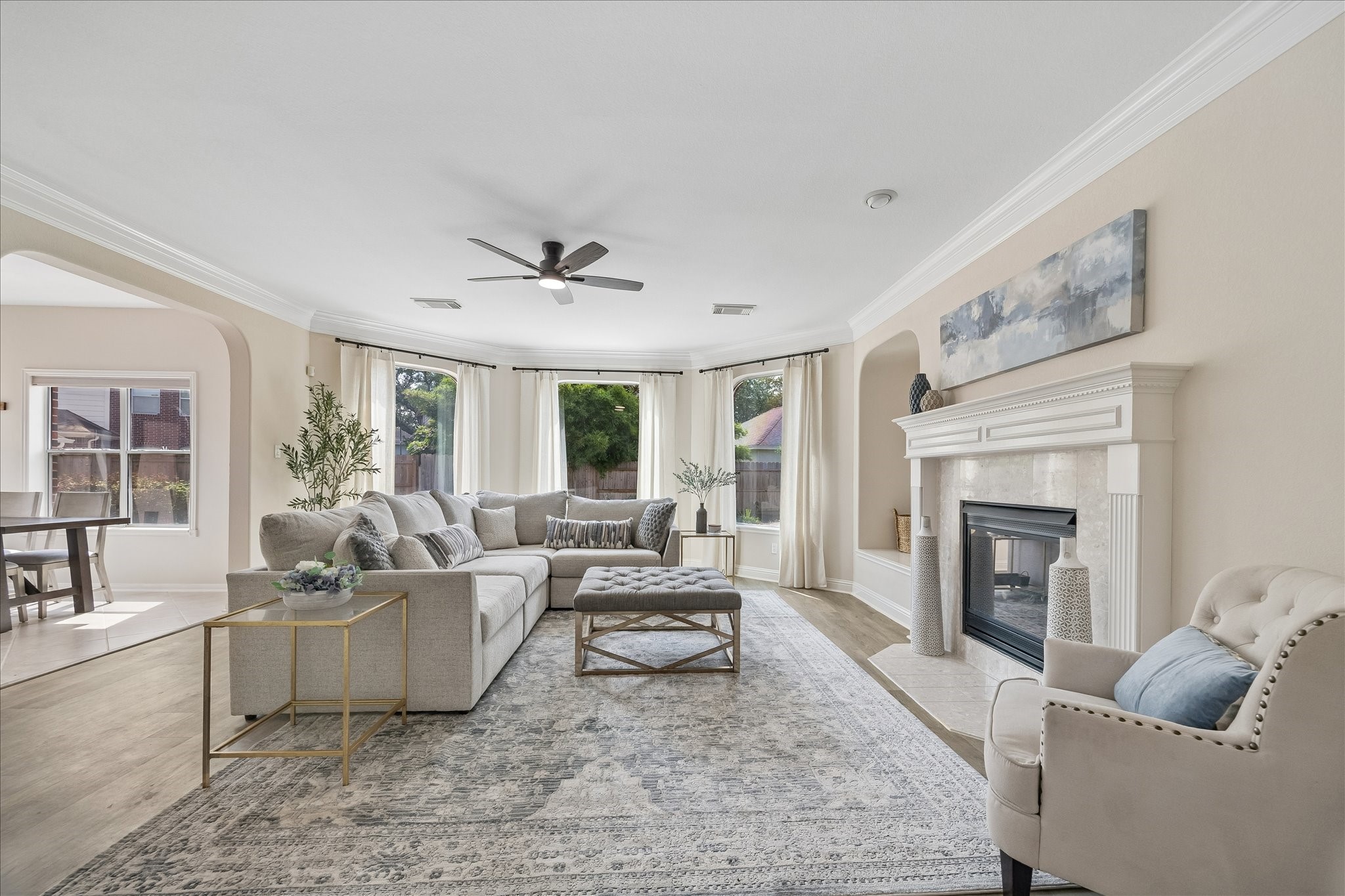 The spacious family room is centered around a beautiful fireplace and framed by oversized windows that bring in abundant natural light. An open design makes it perfect for both everyday living and entertaining. The spacious family room is centered around a beautiful fireplace and framed by oversized windows that bring in abundant natural light. An open design makes it perfect for both everyday living and entertaining.
