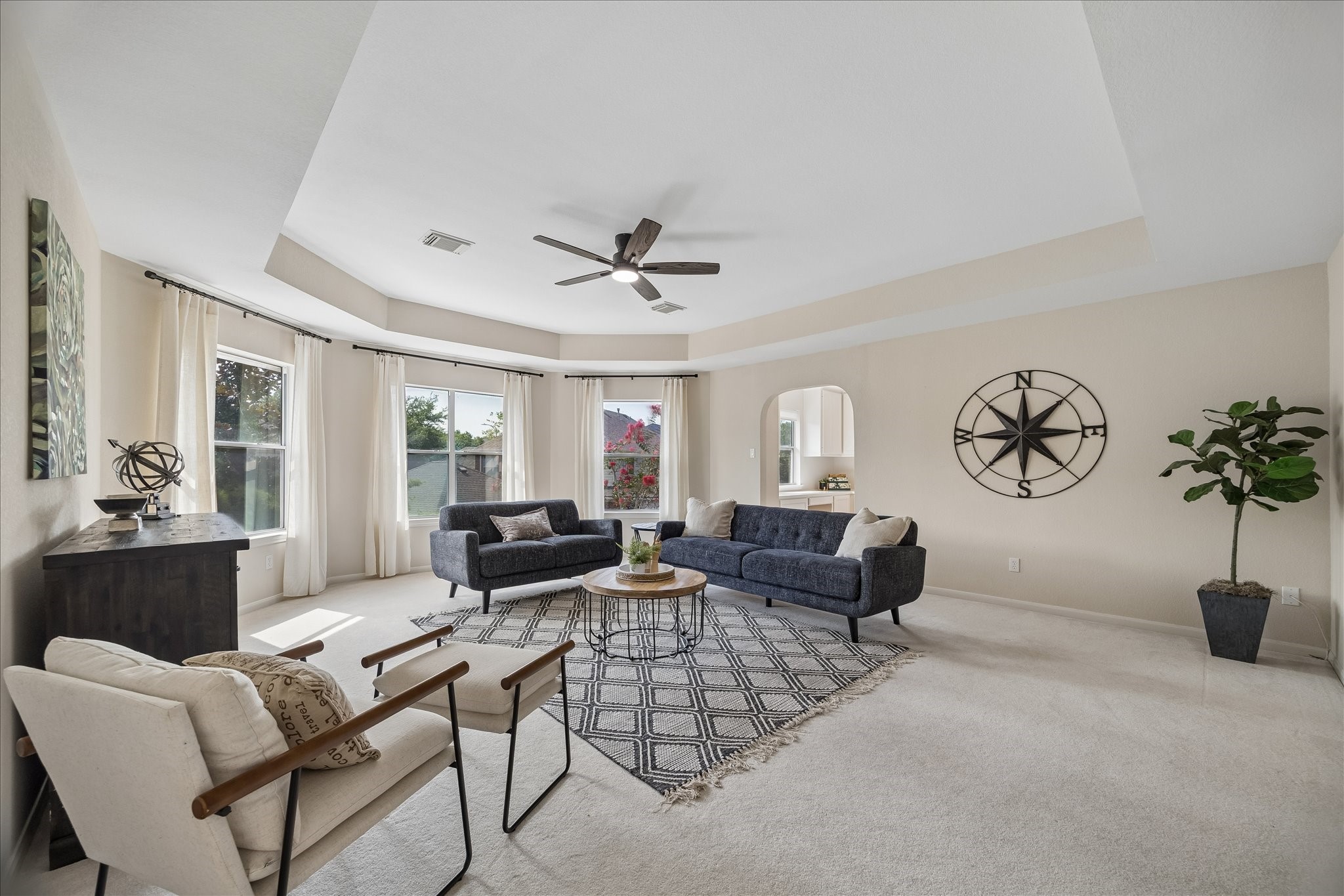 A generous game room offers endless possibilities for movie nights, a playroom, or a second living area. Large windows and a tray ceiling make the space feel bright, open, and welcoming.