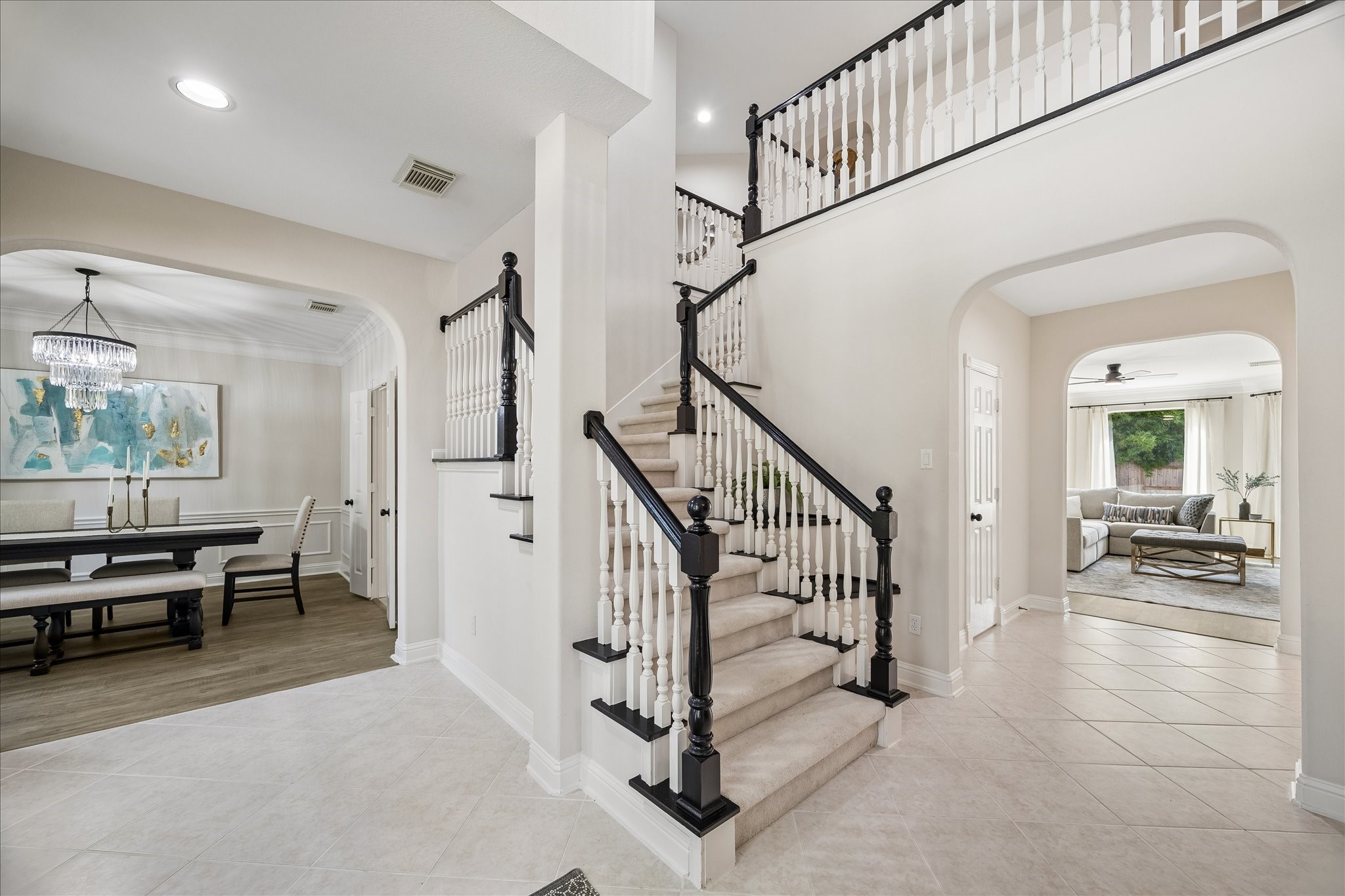 Step inside to a grand two-story foyer featuring an elegant staircase and soaring ceilings that create an unforgettable first impression. The layout offers a seamless flow into the home's main living spaces. Step inside to a grand two-story foyer featuring an elegant staircase and soaring ceilings that create an unforgettable first impression. The layout offers a seamless flow into the home's main living spaces.