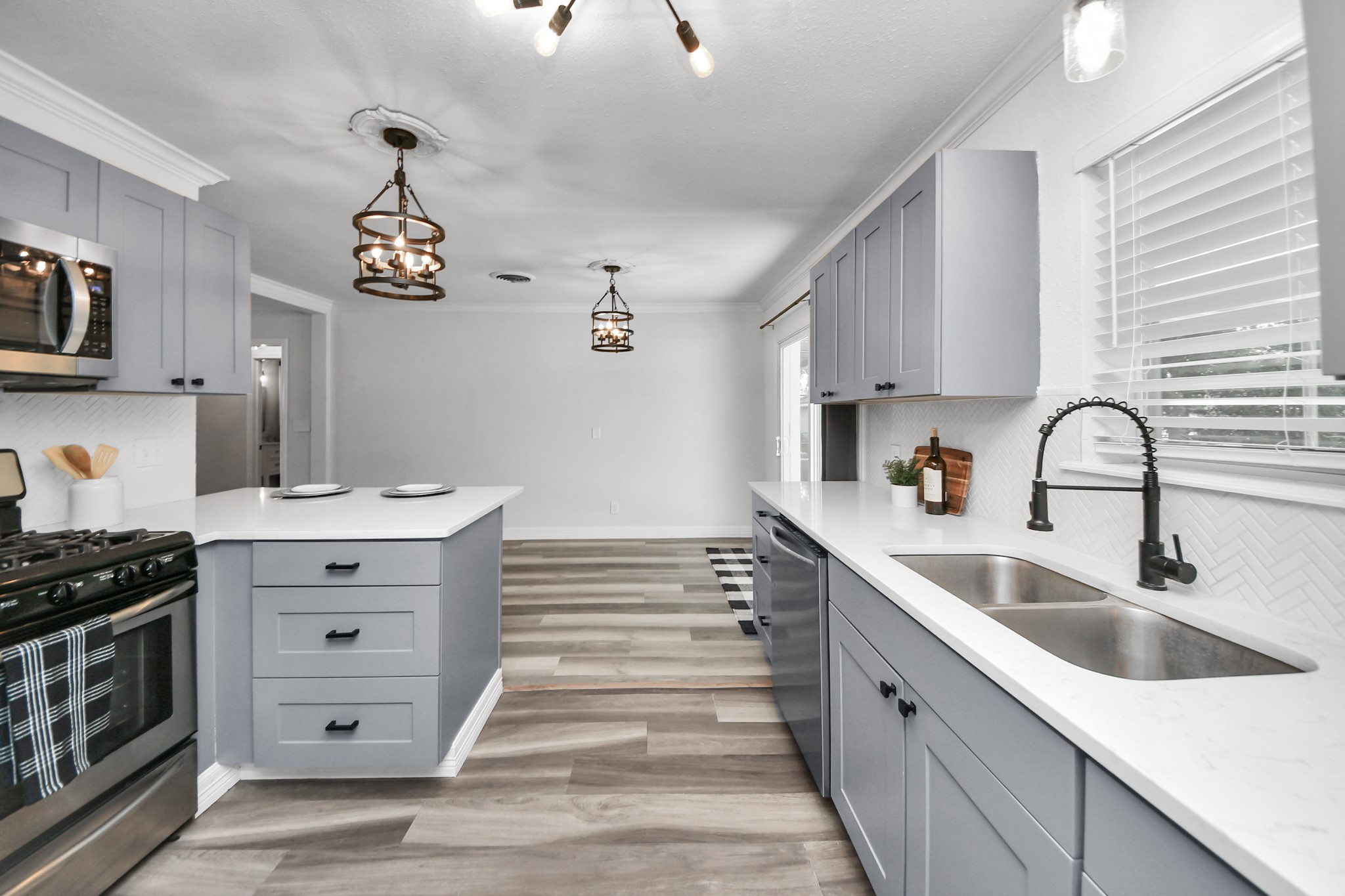 Kitchen with window over the sink, Stainless Steel Appliances overlooking the dining area and backyard access.