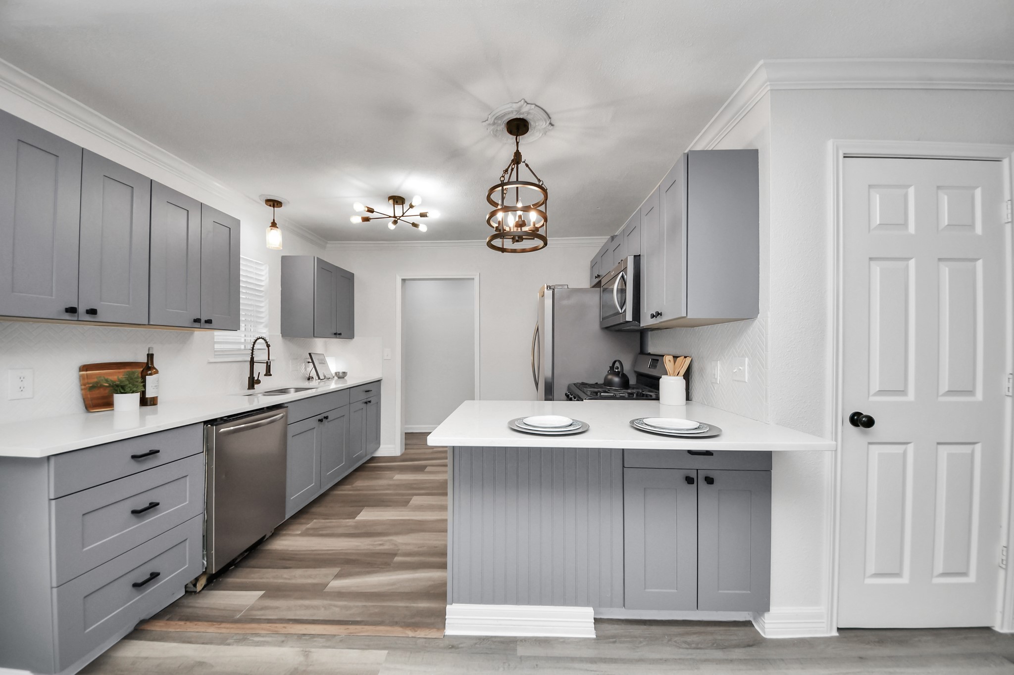 Updated Kitchen with Quartz Counters, Soft close cabinets, and Peninsula breakfast bar. Refrigerator not pictured - but is included! Owner's Primary ensuite through the hallway pictured.