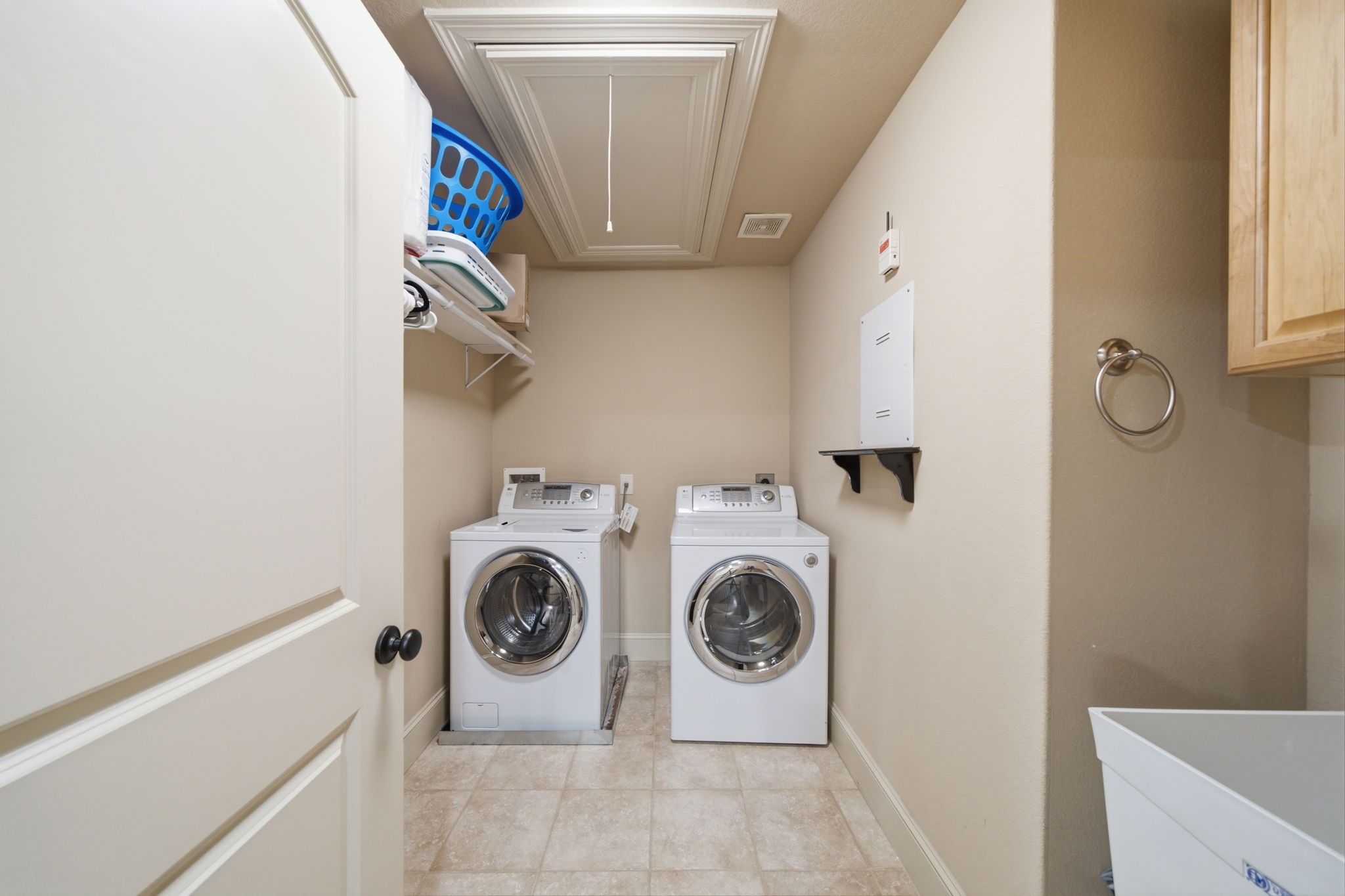 Oversized laundry room has a large laundry sink on the right with ample storage throughout.  There are gas and electric dryer connections (so buyers can bring their appliances of choice).