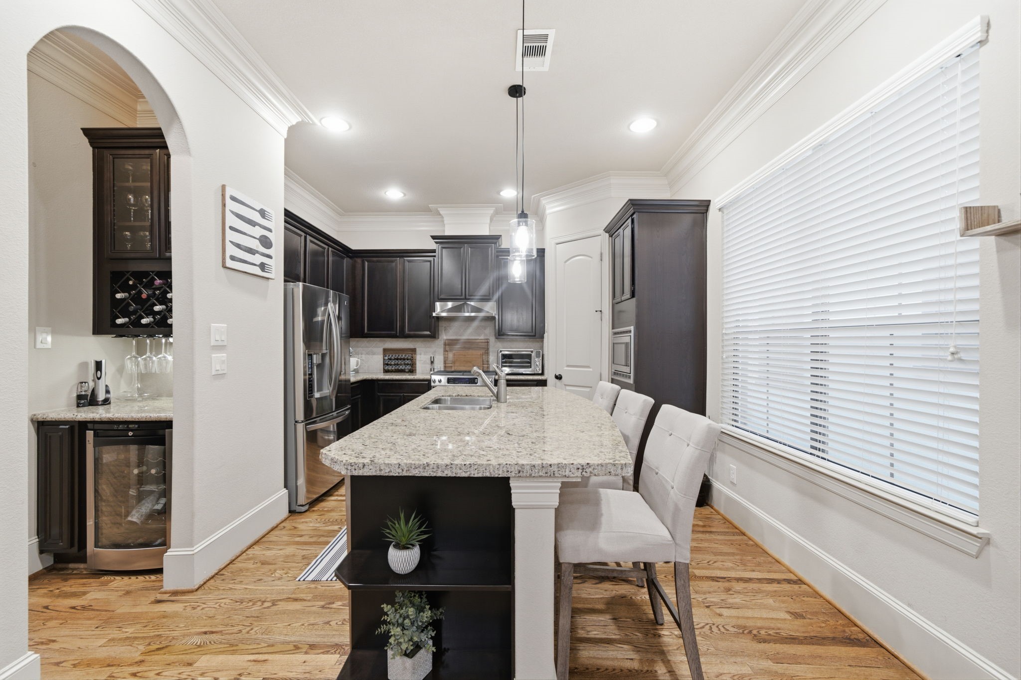The butlers pantry area is perfectly situated between the kitchen and living room for easy entertaining.  Complete with wine rack and glass front cabinetry. The wine/beverage refrigerator is included.
