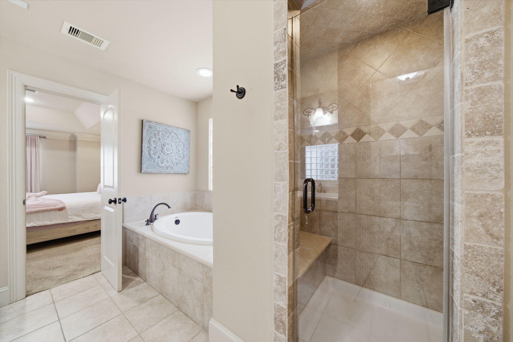 Primary bath has a luxurious soaking tub and separate free standing shower with bench.