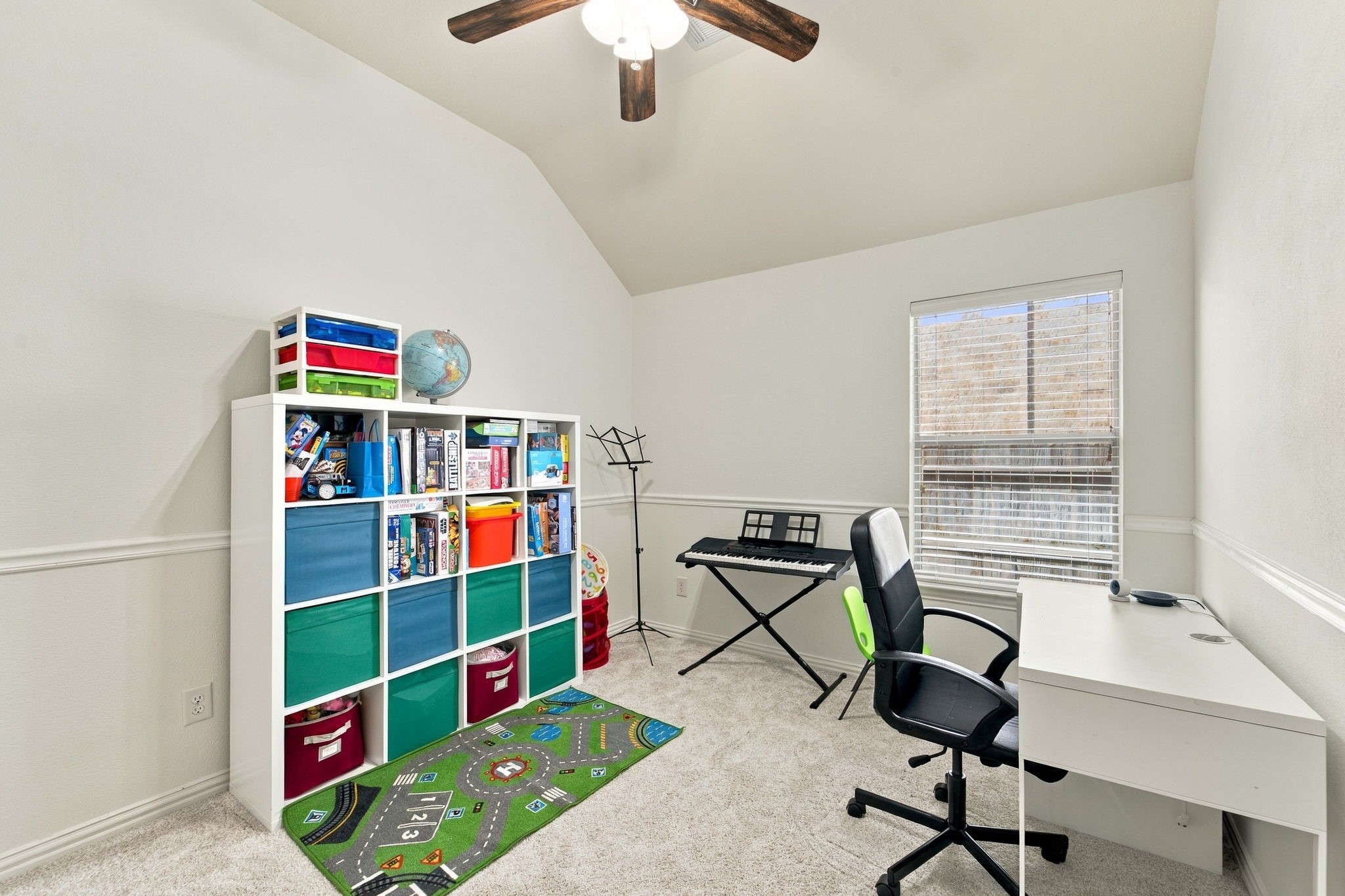 Easy to adapt as your needs change, this secondary bedroom offers carpet, a ceiling fan, and natural light. Use it as a bedroom, playroom, or home workspace.