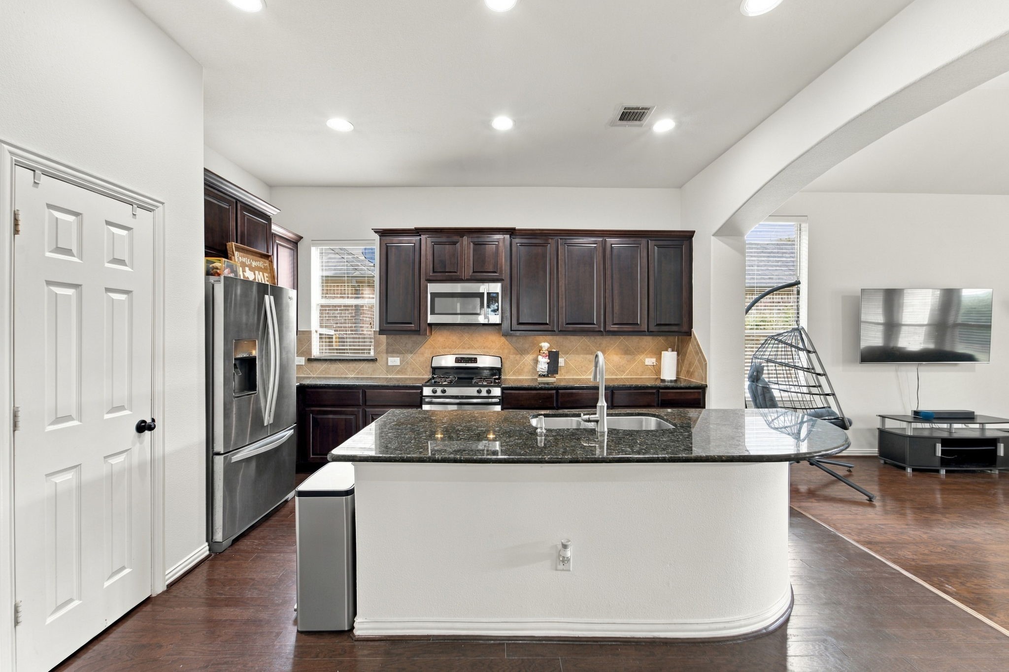 Cooking feels effortless in this bright kitchen, with stainless appliances, a gas range, and plenty of cabinet storage. Recent updates like the new dishwasher and faucet make it practical for daily life.