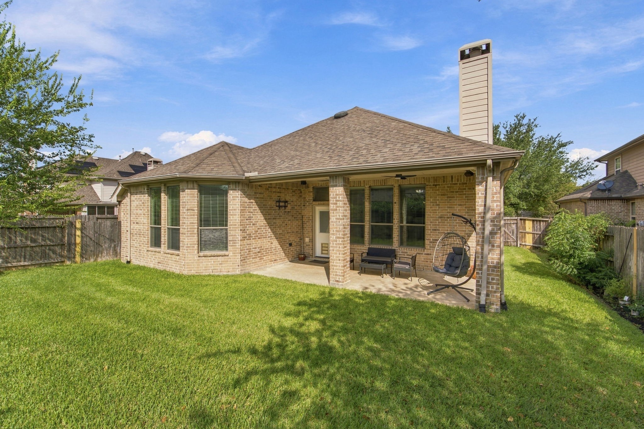 The extended covered patio with two ceiling fans is made for outdoor living, from morning coffee to weekend cookouts. The fenced backyard gives you green space to enjoy, with room to play and relax.