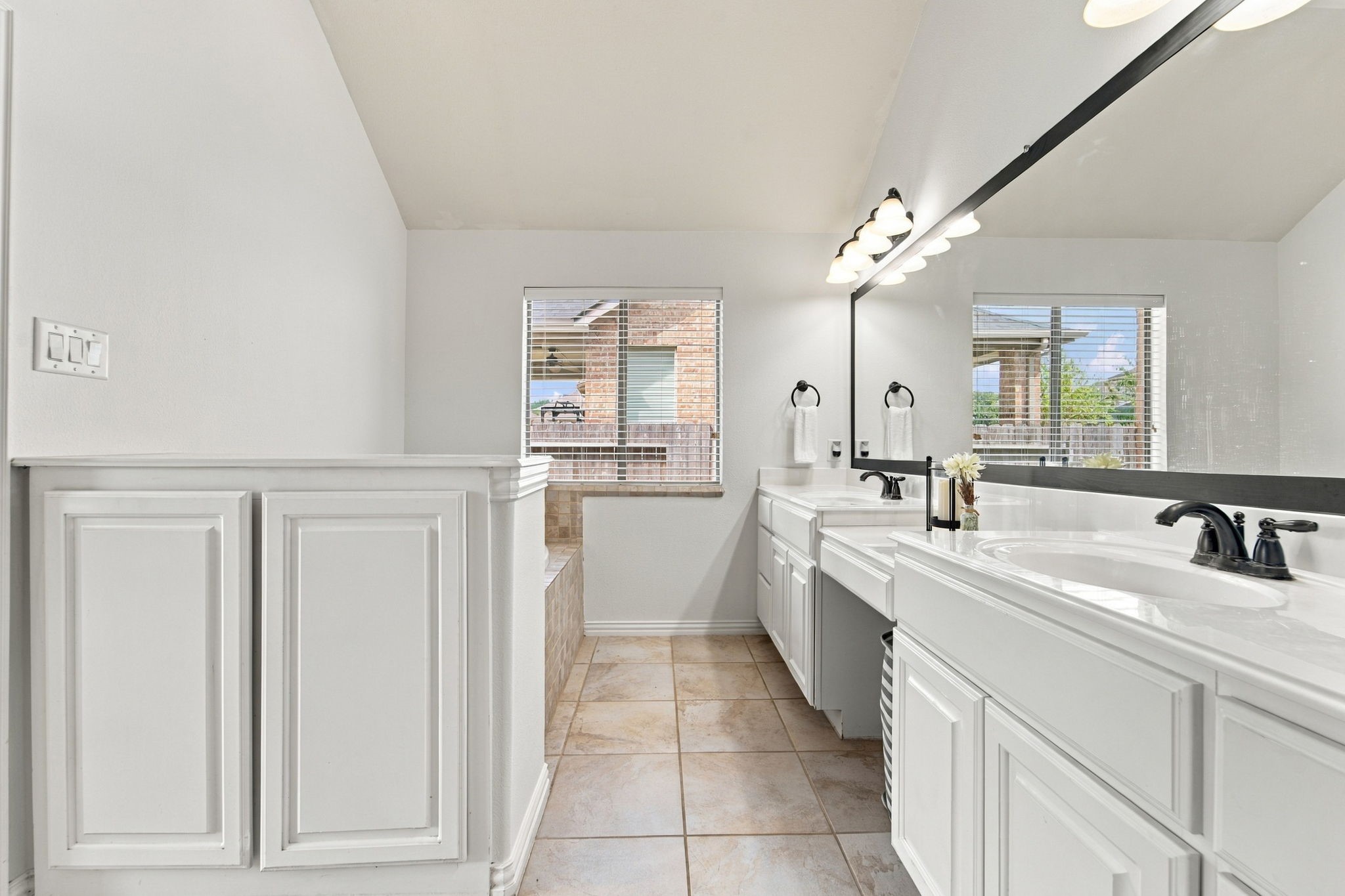 Double sinks and generous counter space make busy mornings easier in this primary bath. Its paired with a soaking tub and a separate shower, a layout that works well for everyday routines.