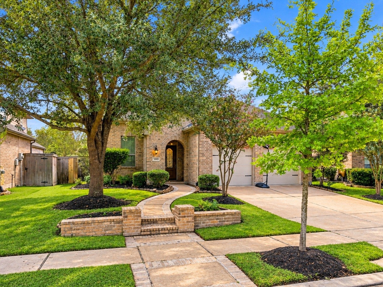 Ready for you to call home, this charming one-story brick home pairs classic curb appeal with a two-car attached garage, mature trees, and landscaped beds that give it a warm welcome.